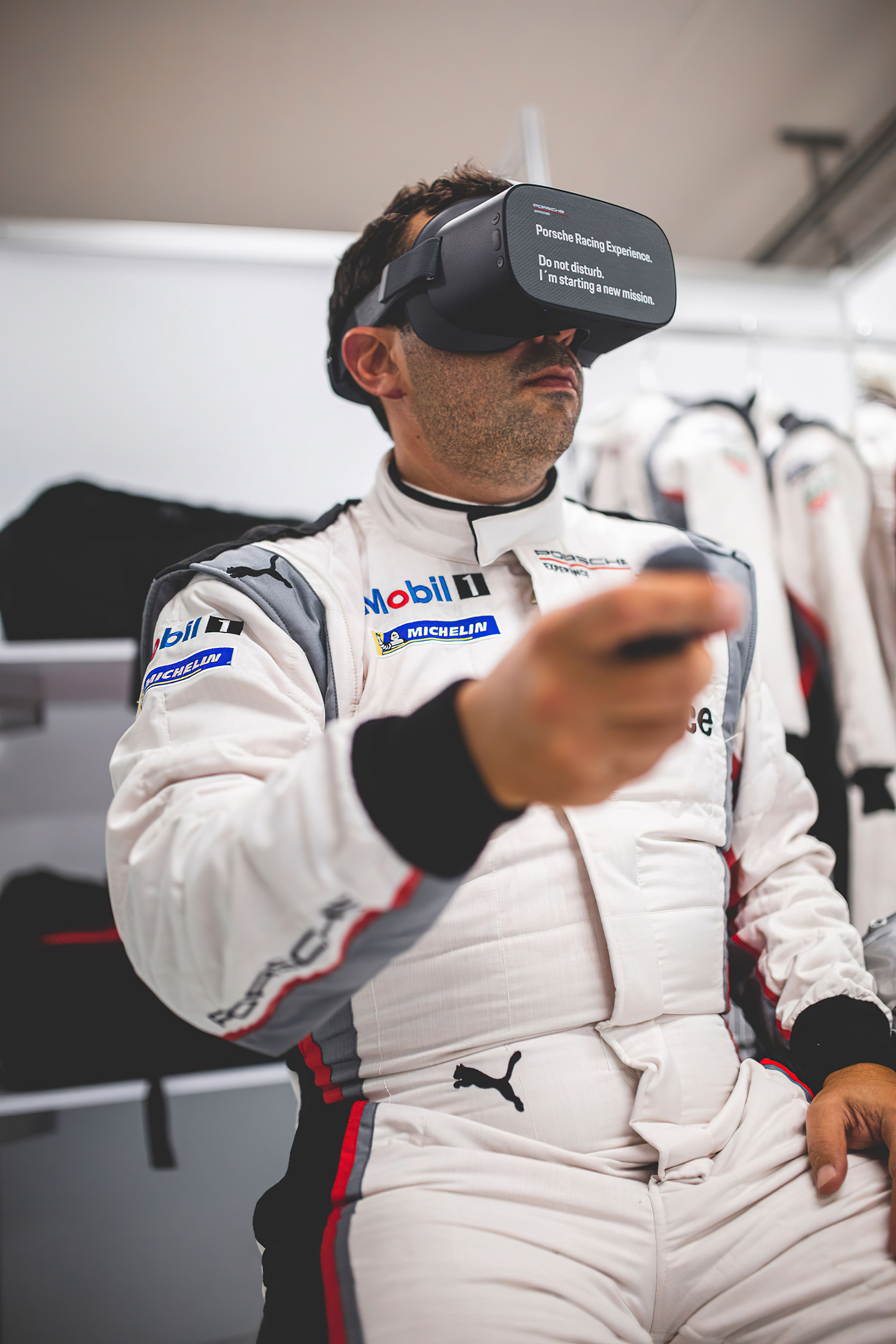Participant of the Porsche Racing Experience practicing with VR glasses
