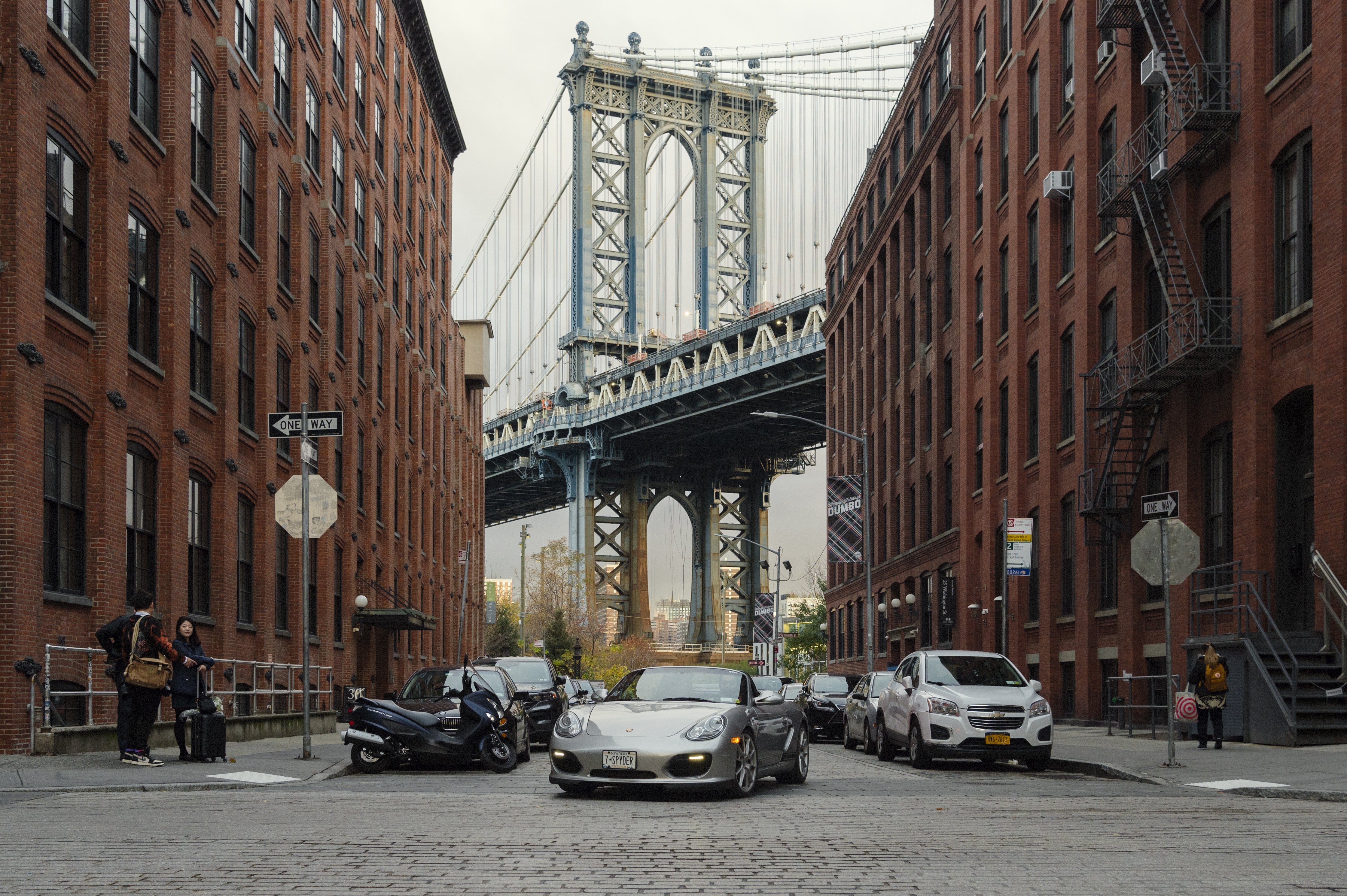 Porsche Boxster Spyder under Brooklyn Bridge, New York in background