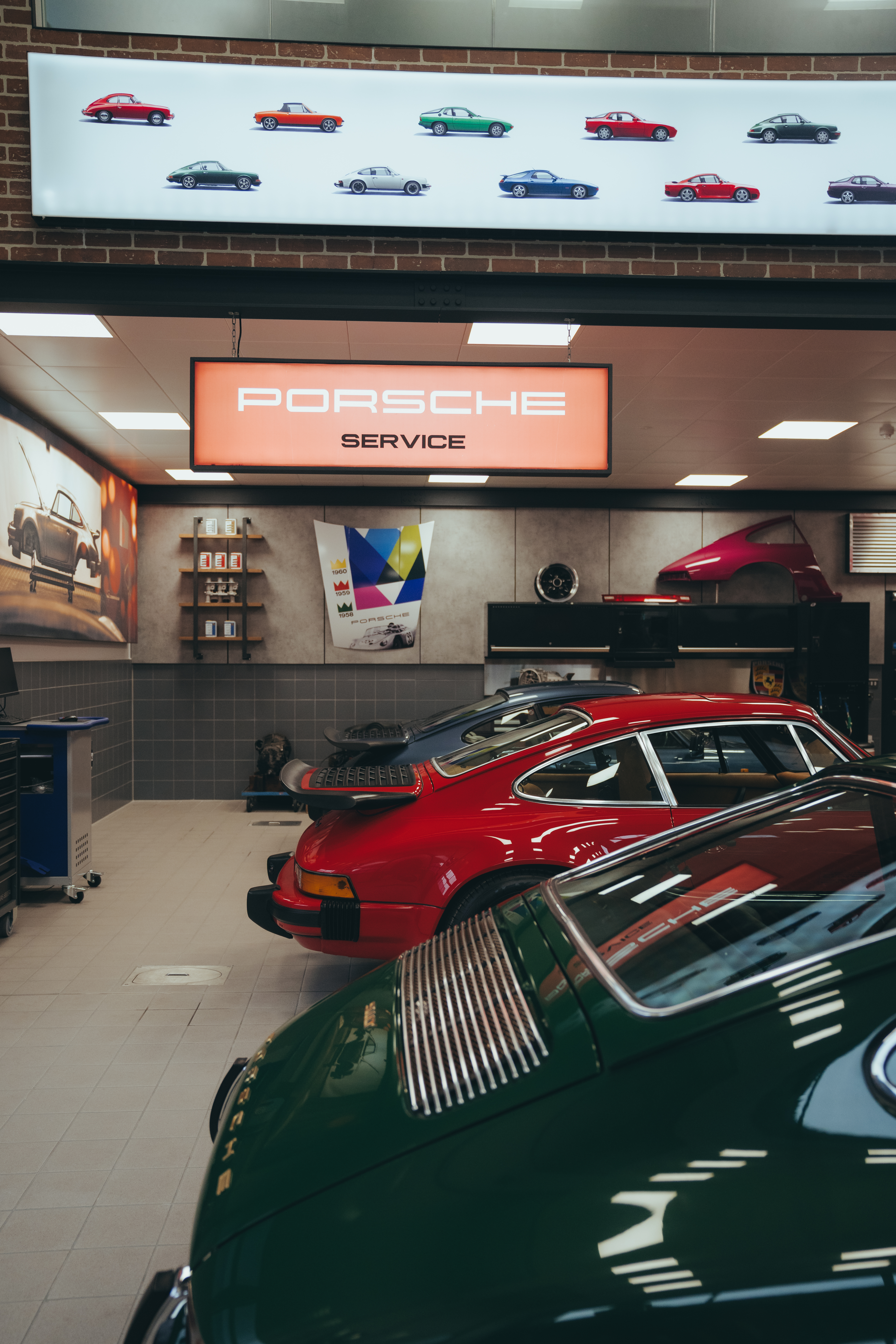 Line of classic Porsche 911 cars in a workshop