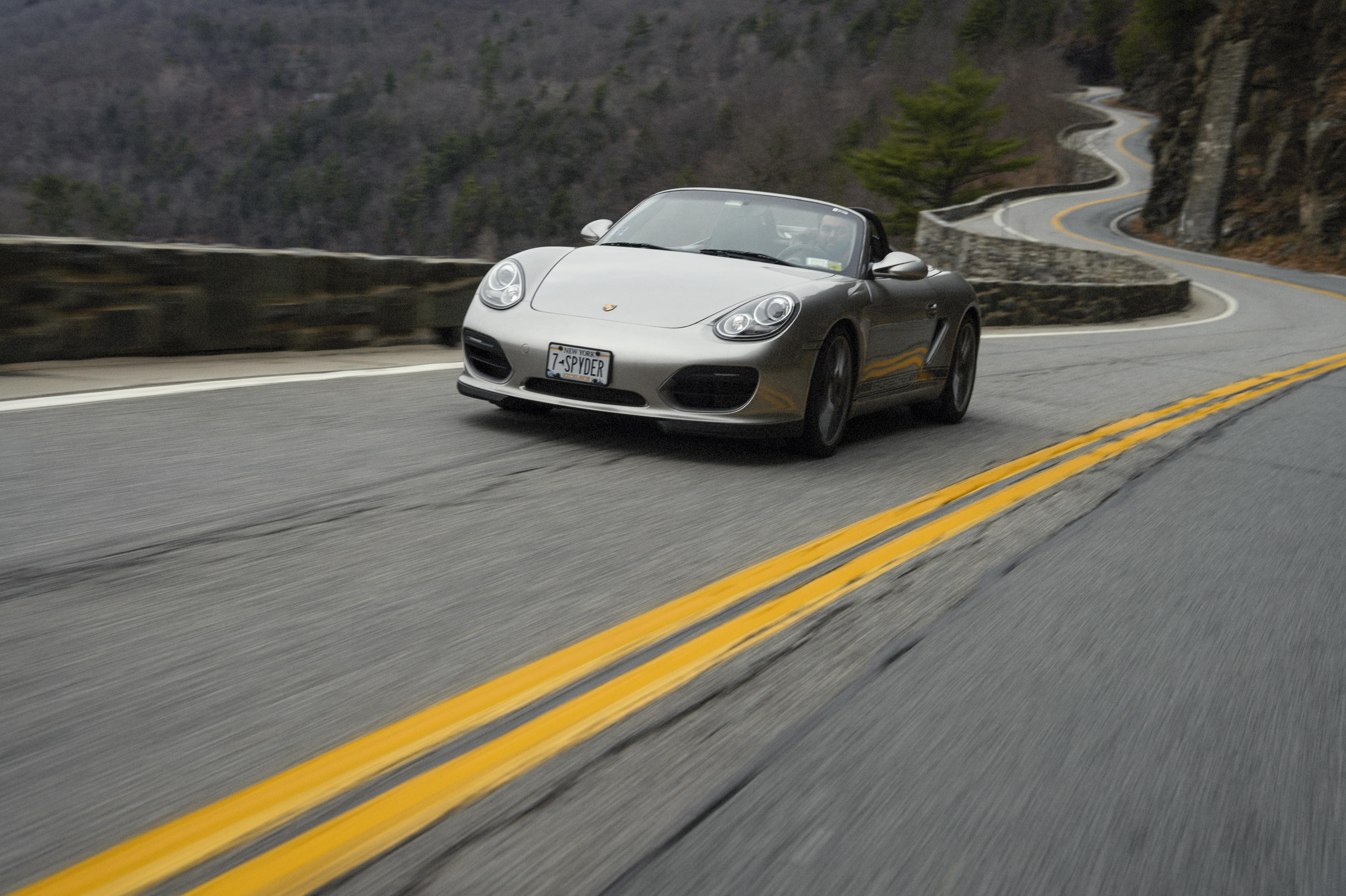Porsche Boxster Spyder driving on winding mountain road