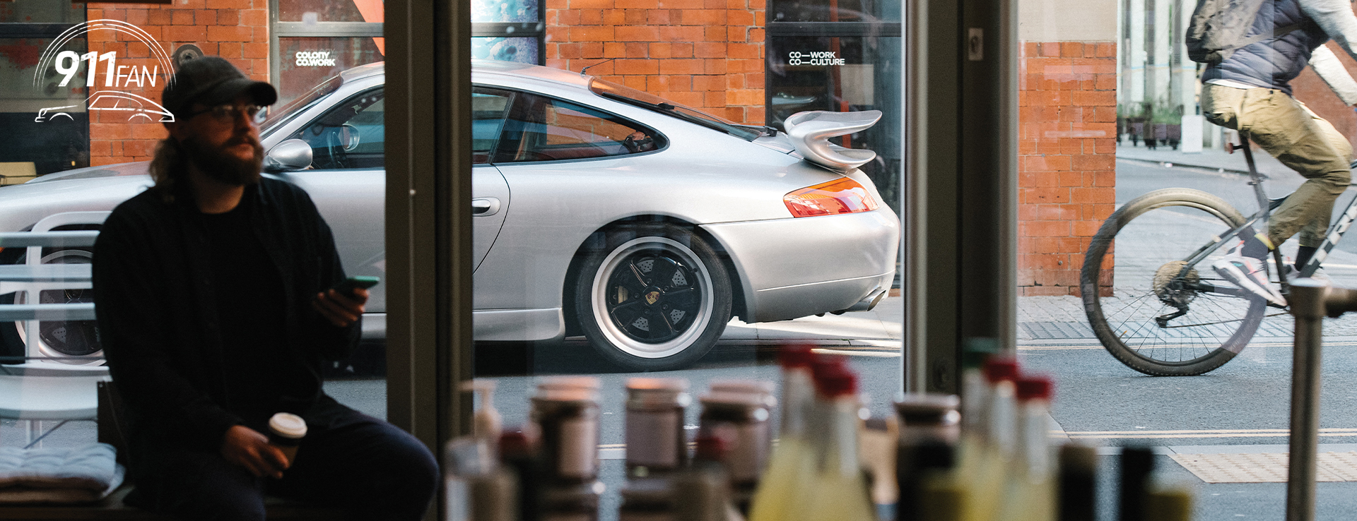View of Porsche 911 (Type 996) through café window