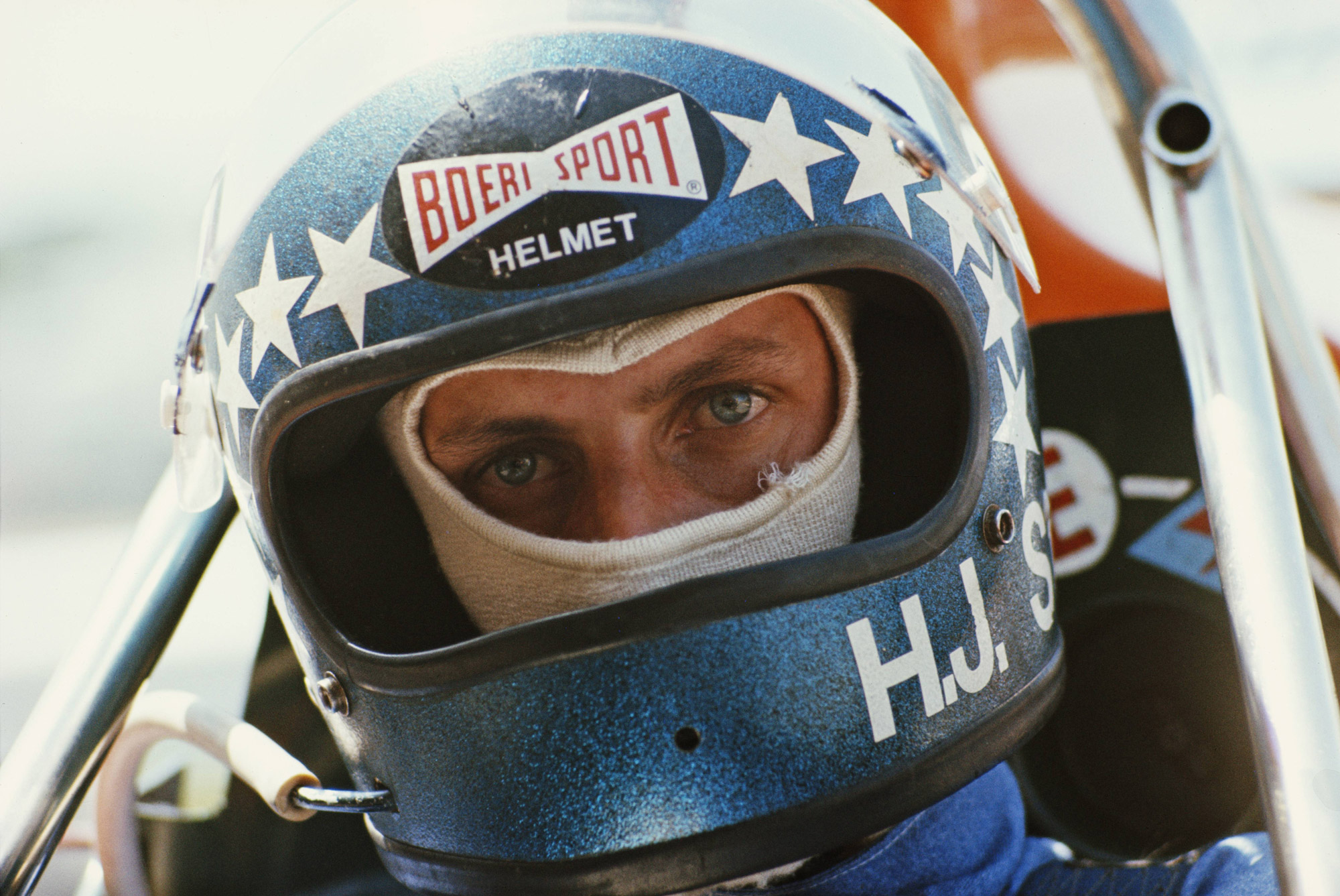 Race driver Hans-Joachim Stuck in blue helmet with white stars