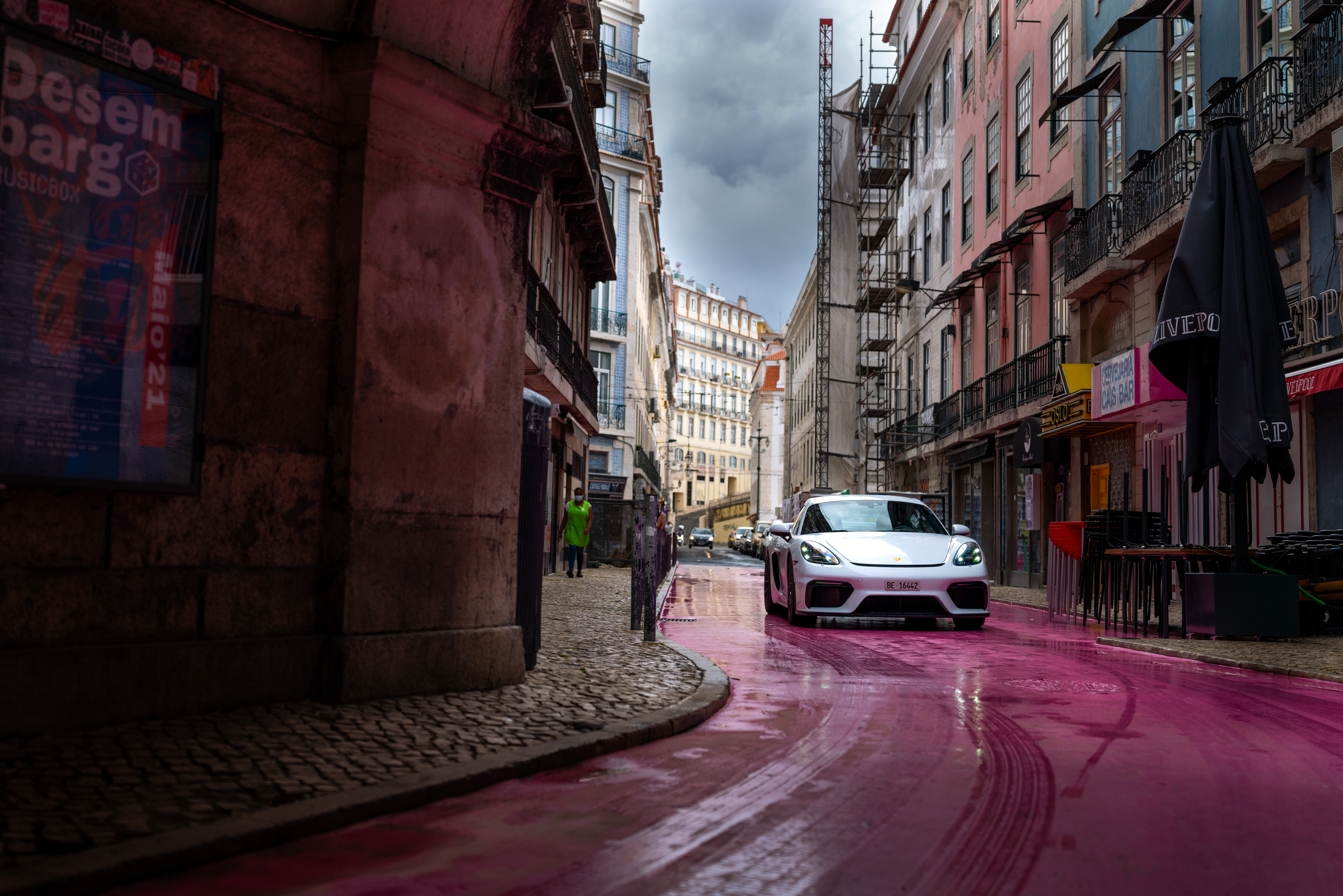 White Porsche 718 Cayman GT4 on pink Lisbon street