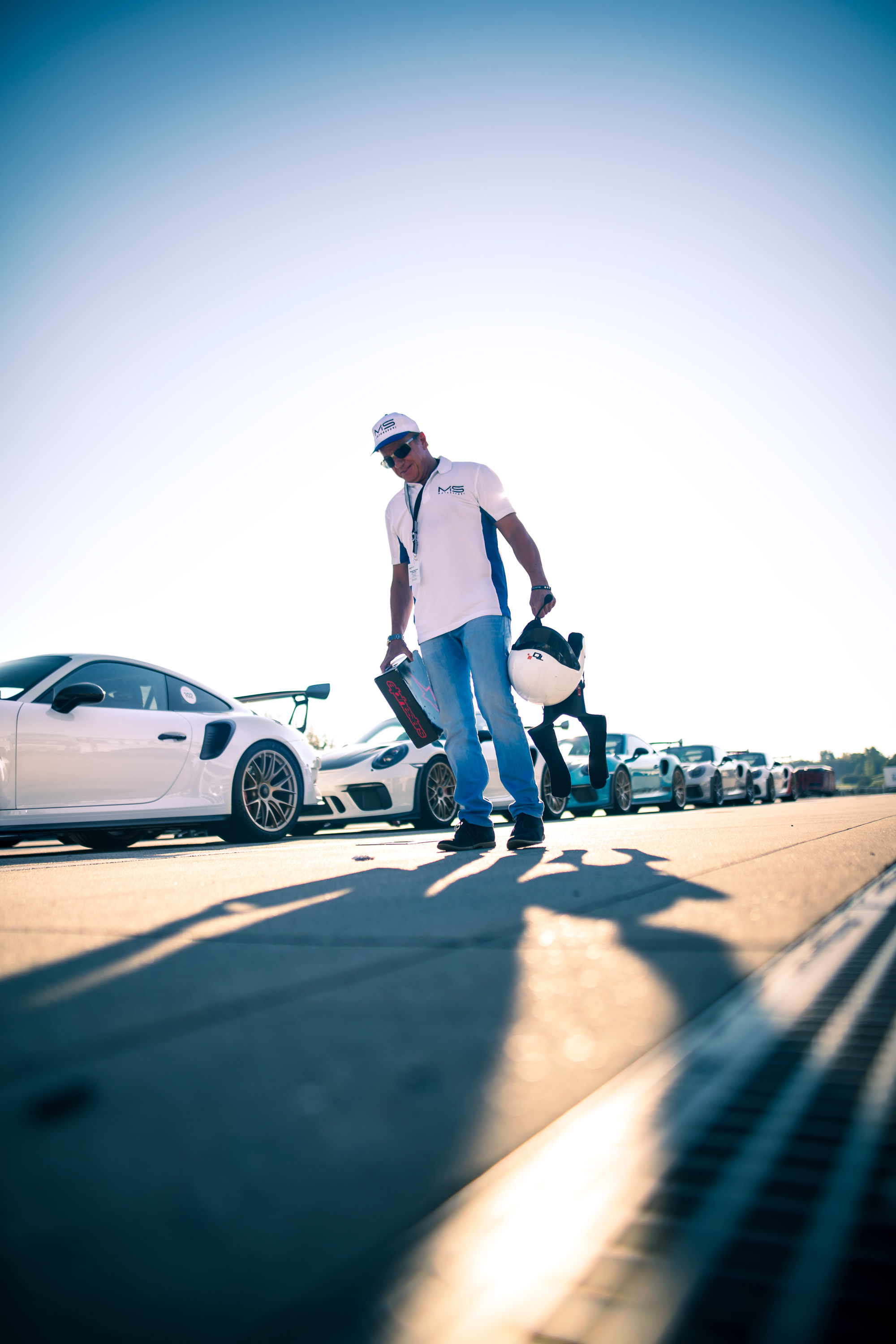 A man standing in front of a line of cars