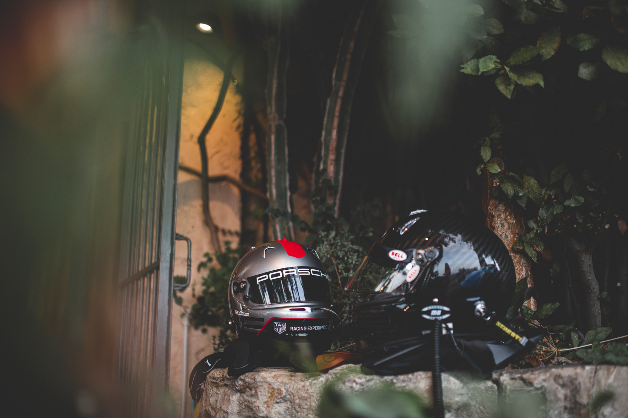 Two Porsche racing helmets placed on restaurant wall