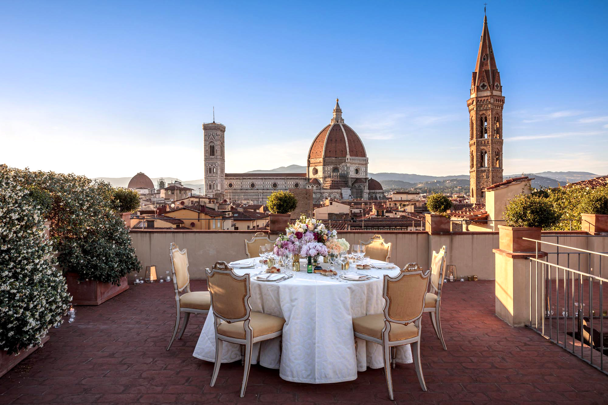 Roof terrace with dining table and view of Florence’s Duomo