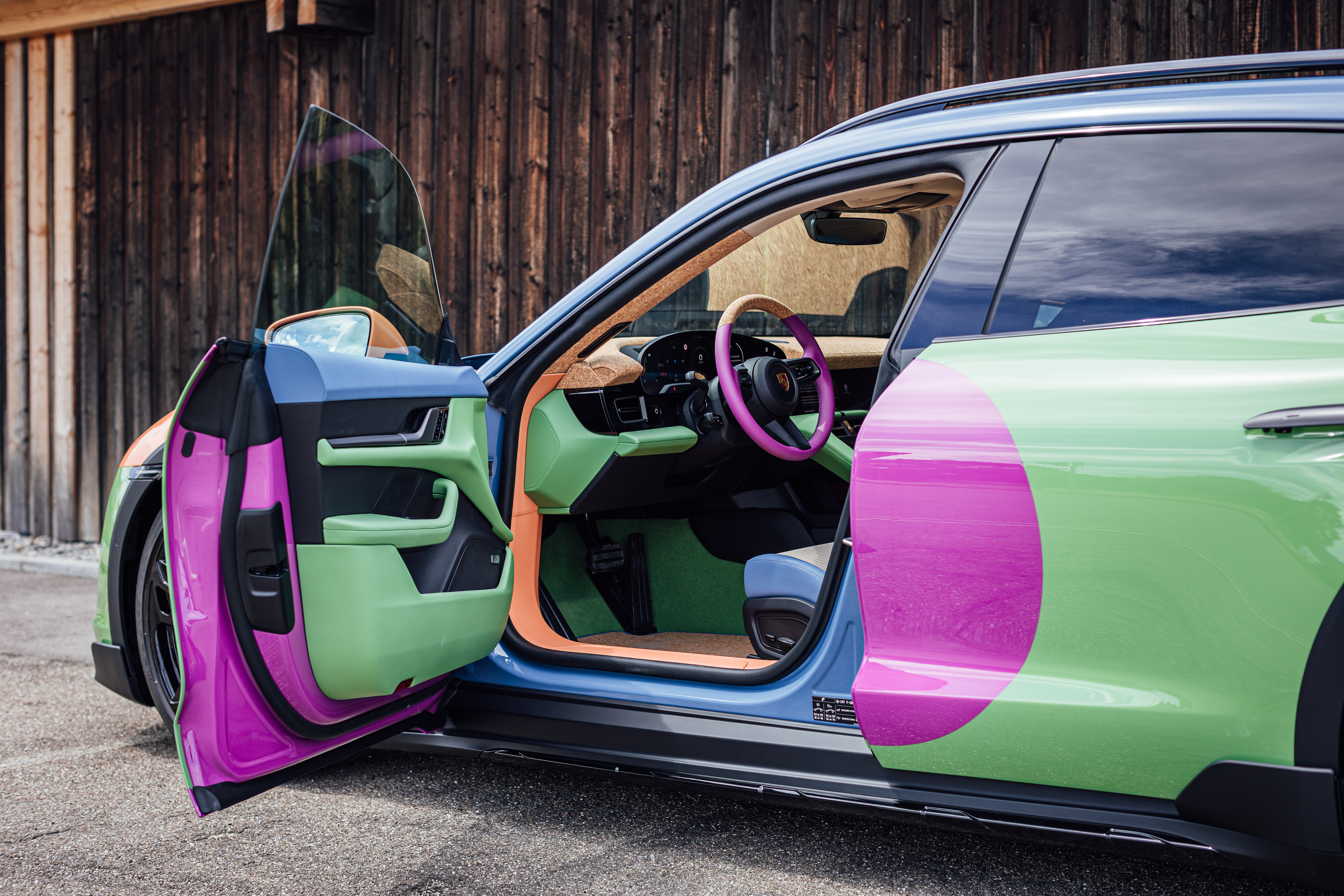 Multicoloured Taycan Cross Turismo with driver’s door open