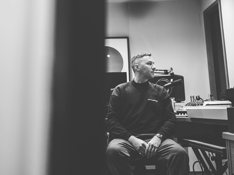 Black and white shot of Benji B sat in studio