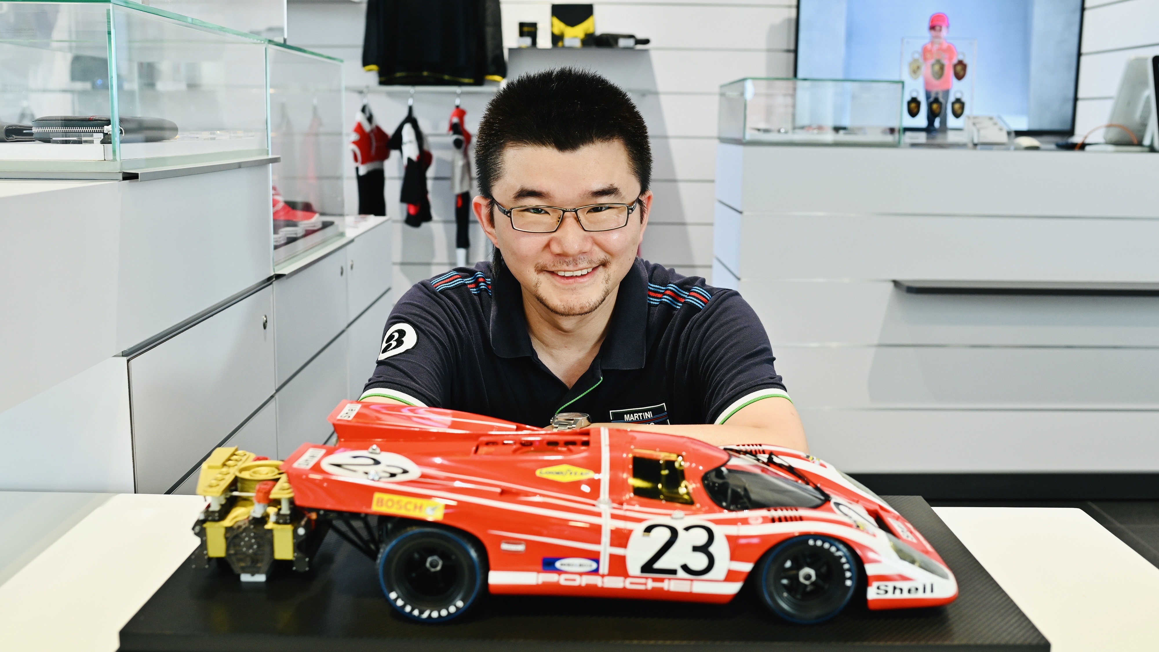 Man with scale model of Porsche 917 in Salzburg livery