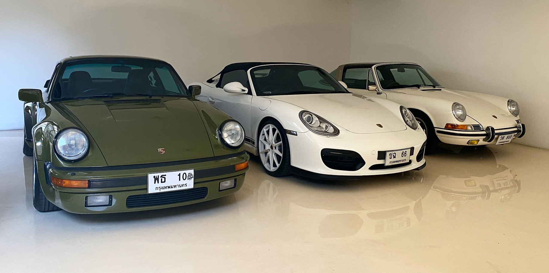 Three Porsche models in a garage