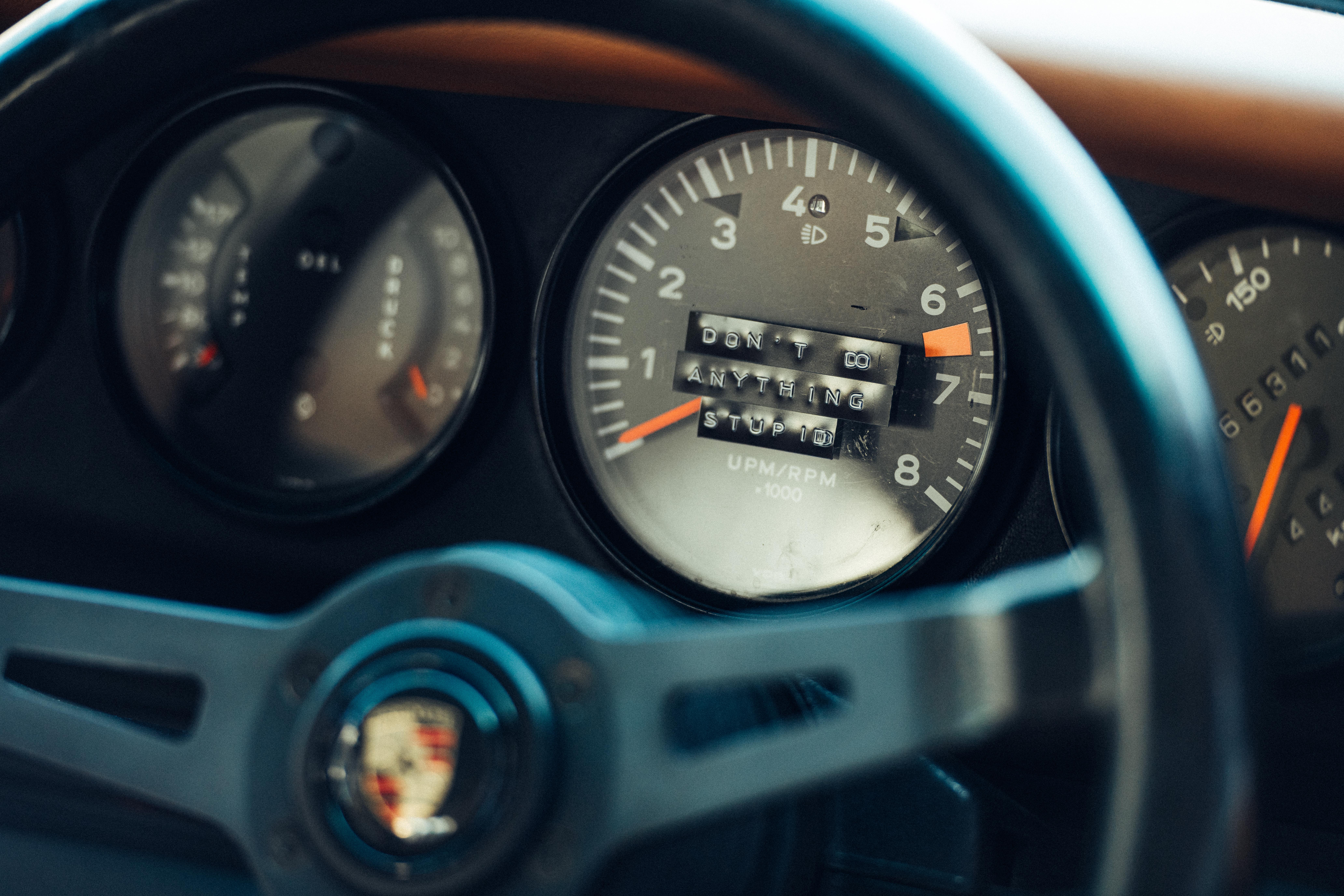 The words, ‘Don’t do anything stupid’ on car tachometer