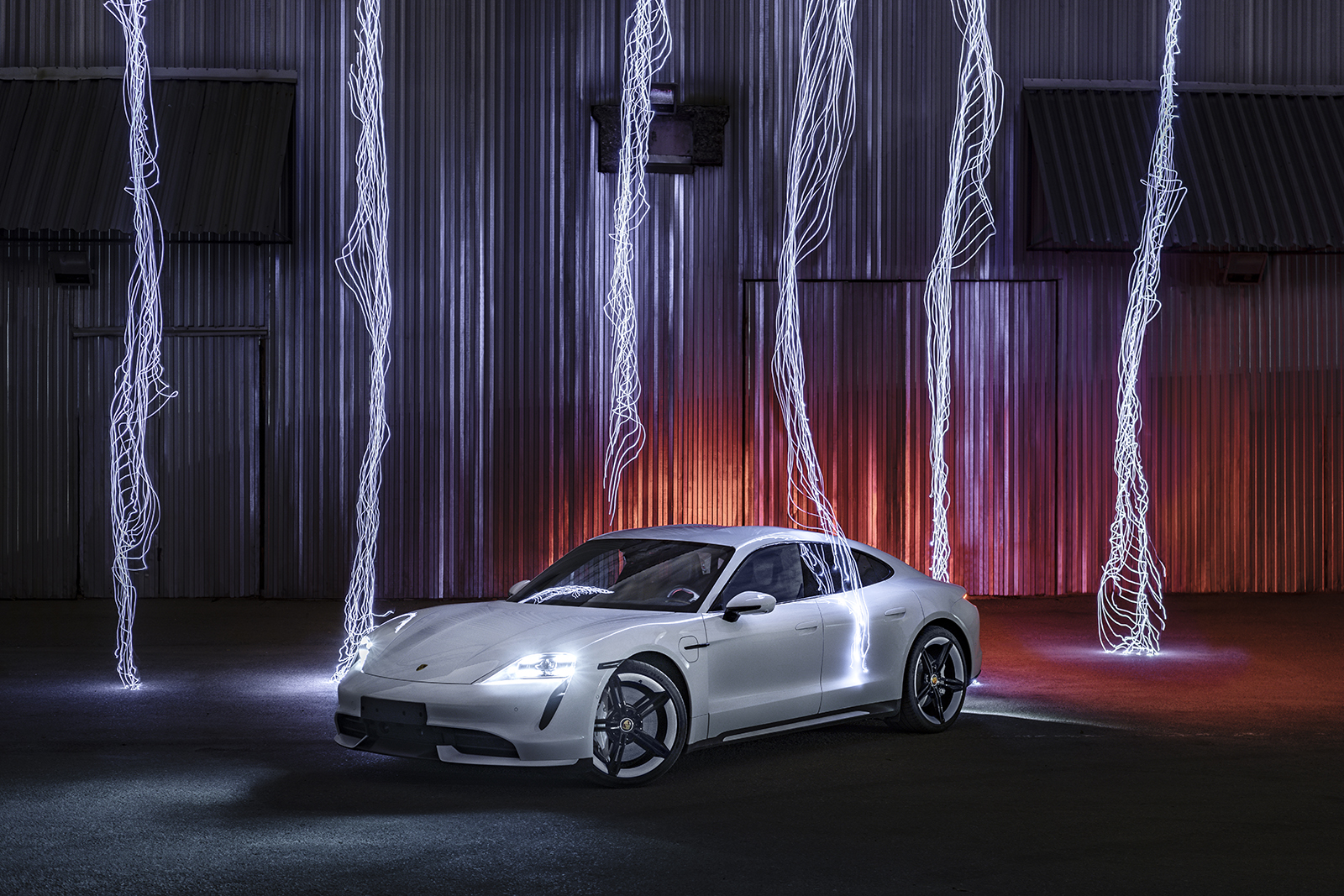 Porsche Taycan shot with dramatic colours and striking light effects