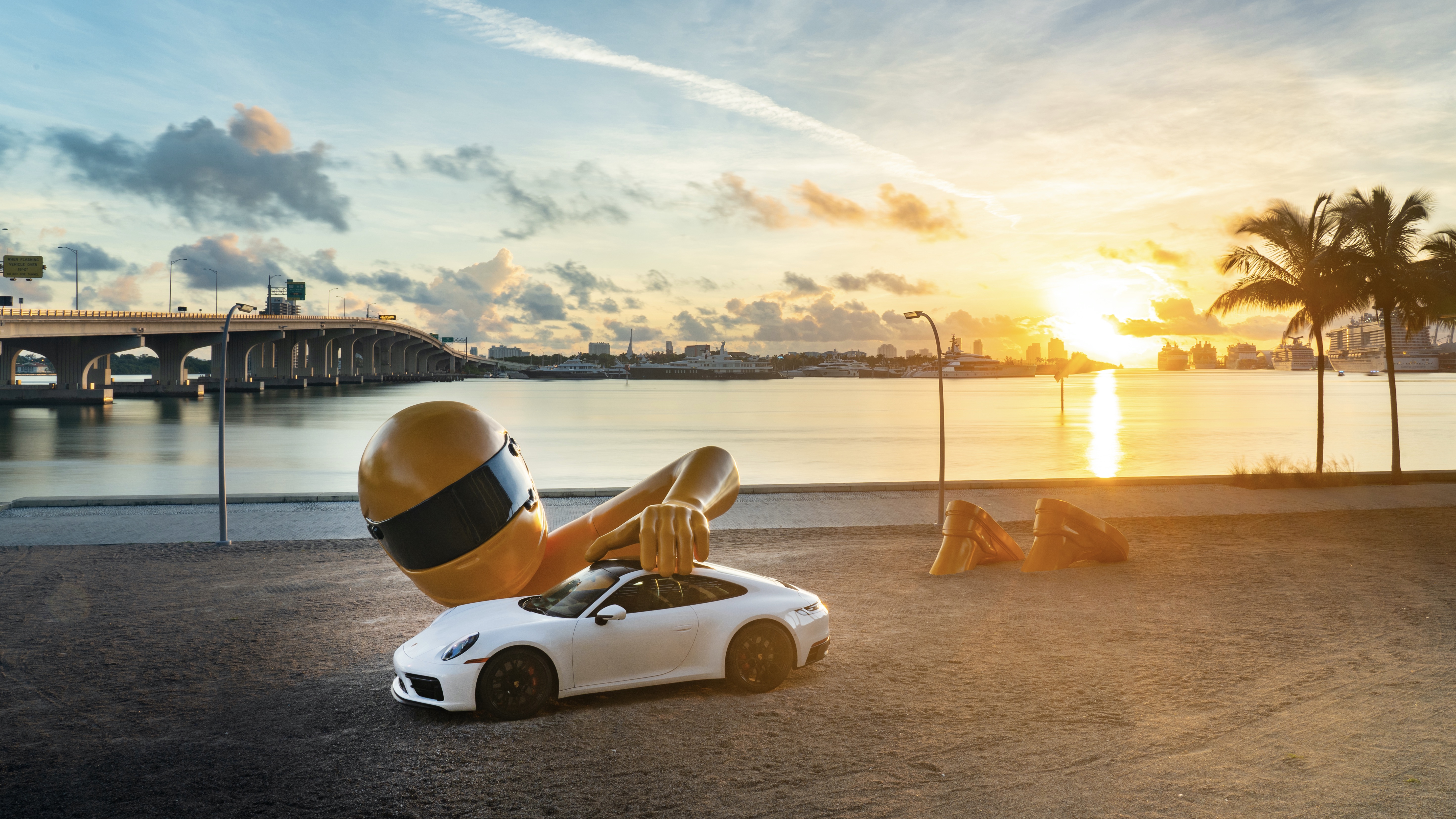 Chris Labrooy sculpture of driver and Porsche 911 at sunset