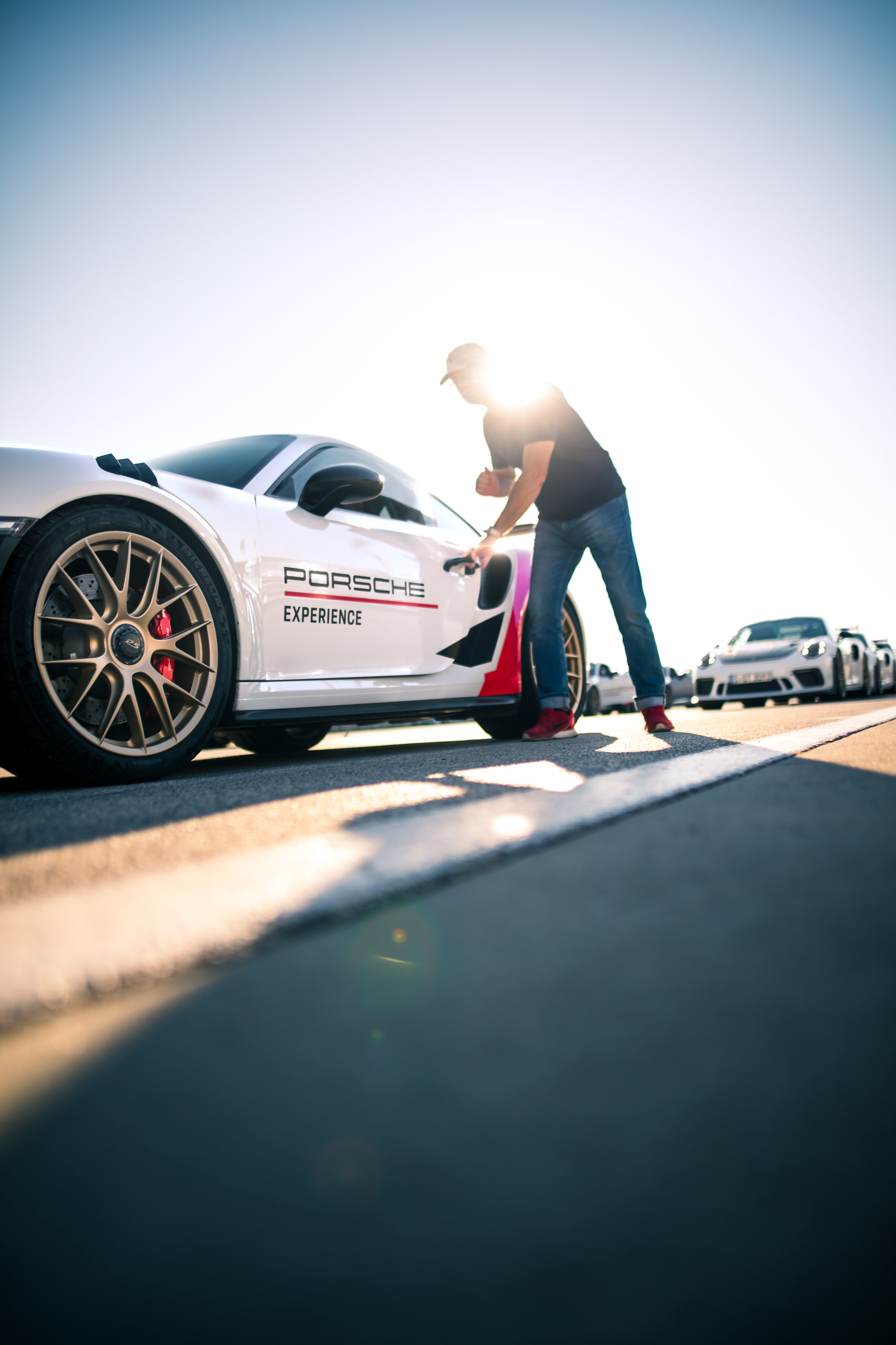 Porsche Track Experience participant opens door of car