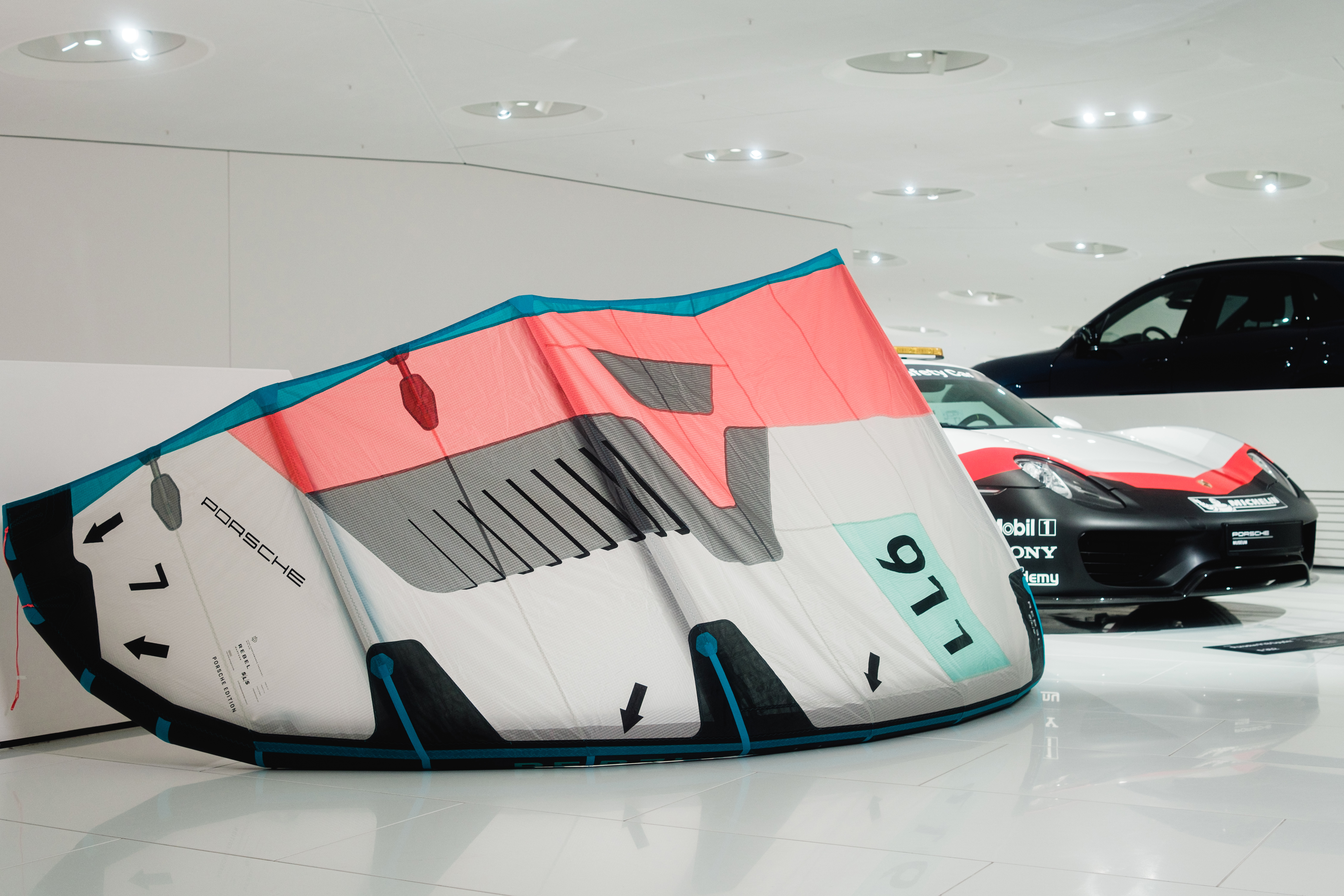 Porsche 911 Duotone kite lying inside all-white Porsche Museum