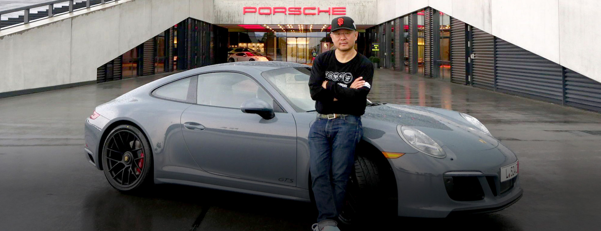 Man outside Porsche Delivery Centre with grey 911 Carrera GTS