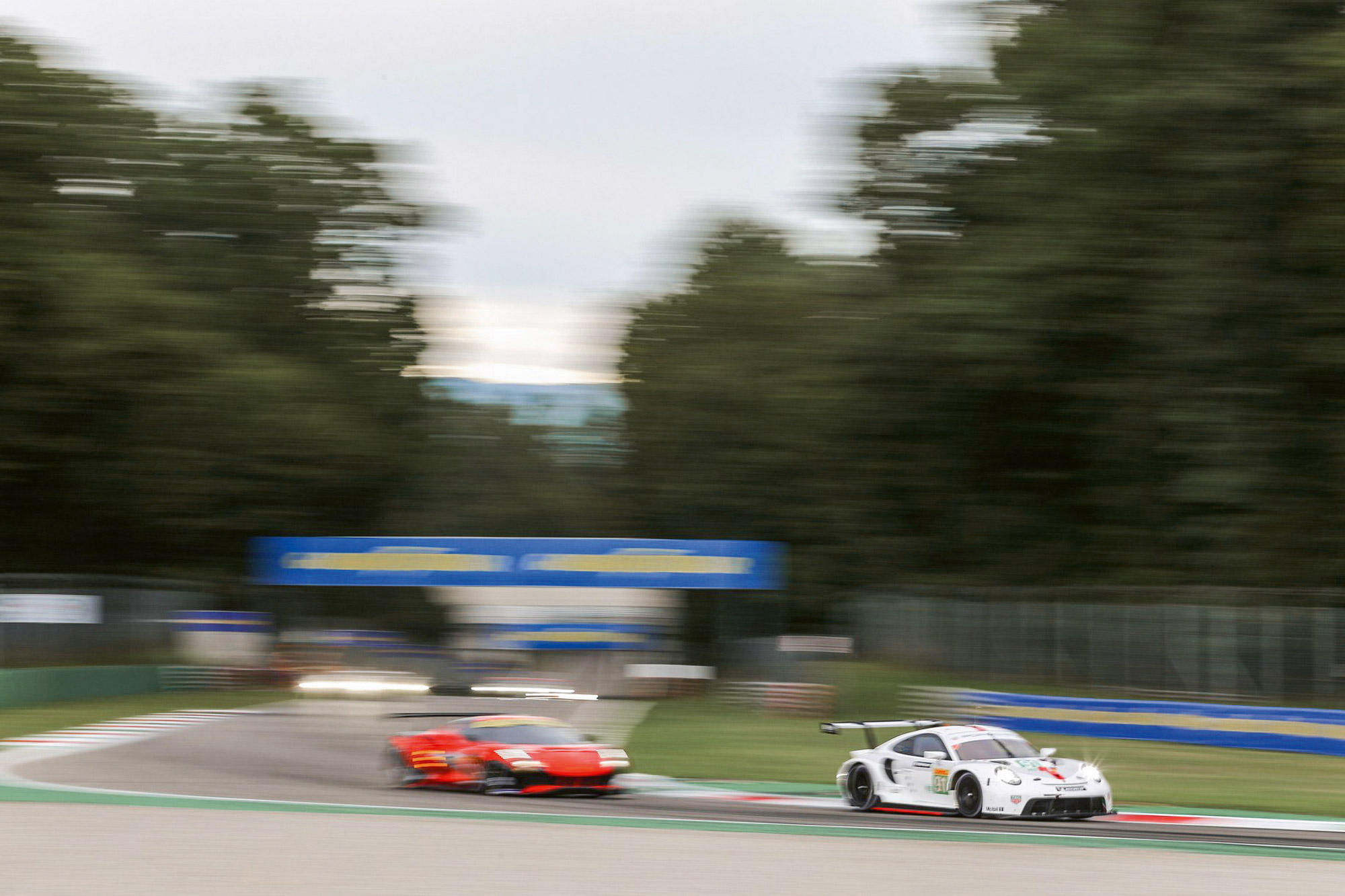 Two racing cars during a race in Monza