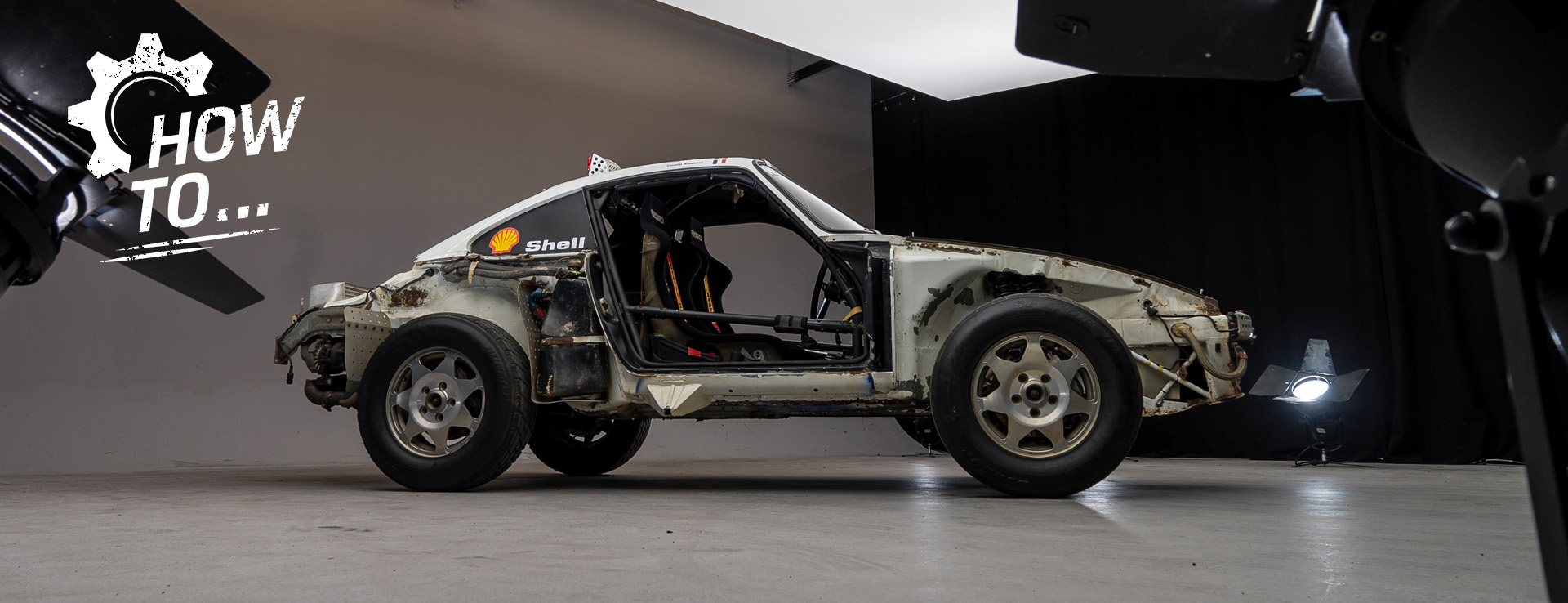 Stripped-down Porsche 959 with doors removed in a photo studio