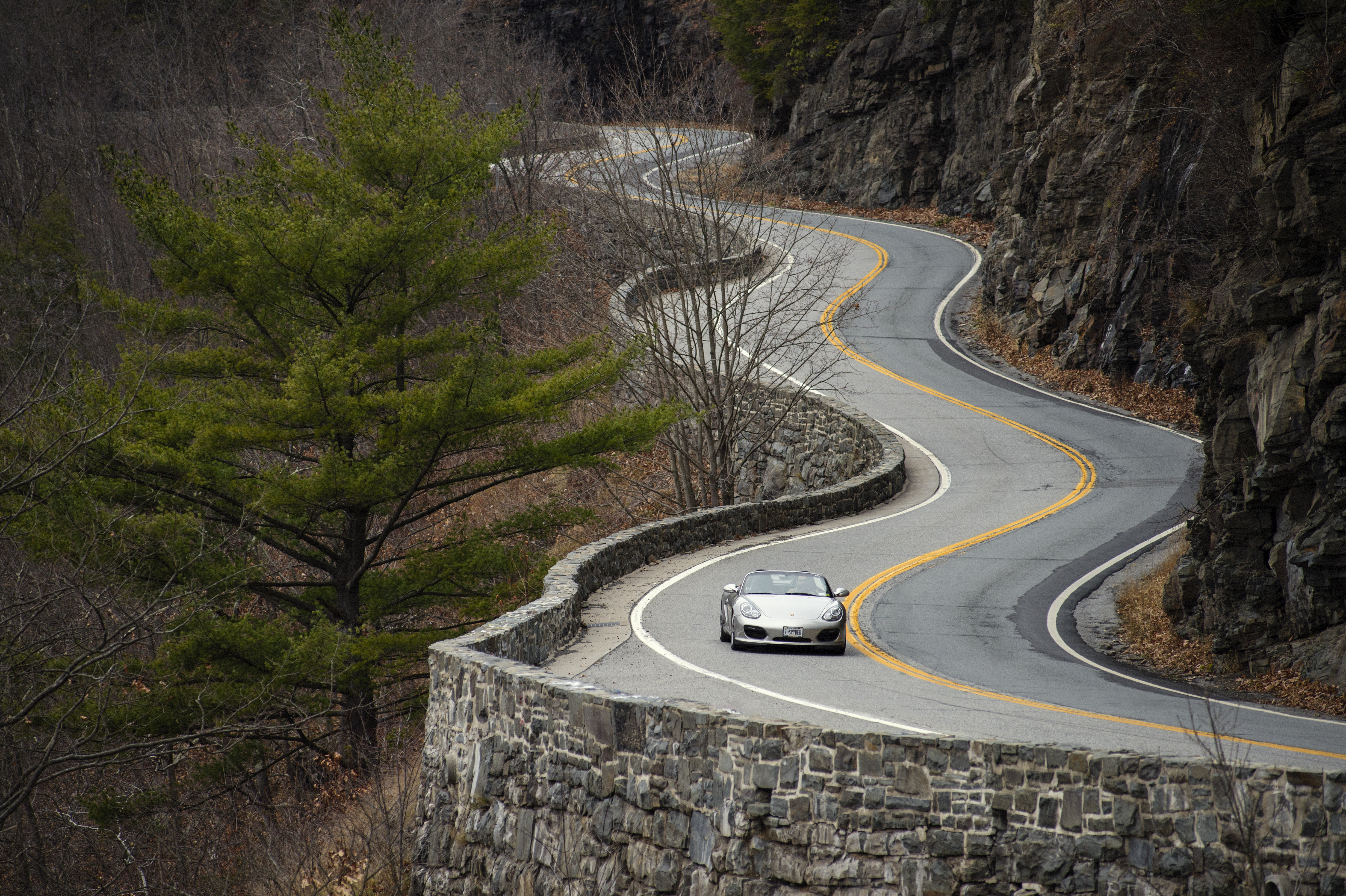 Silver classic Boxster Spyder or winding New York State road