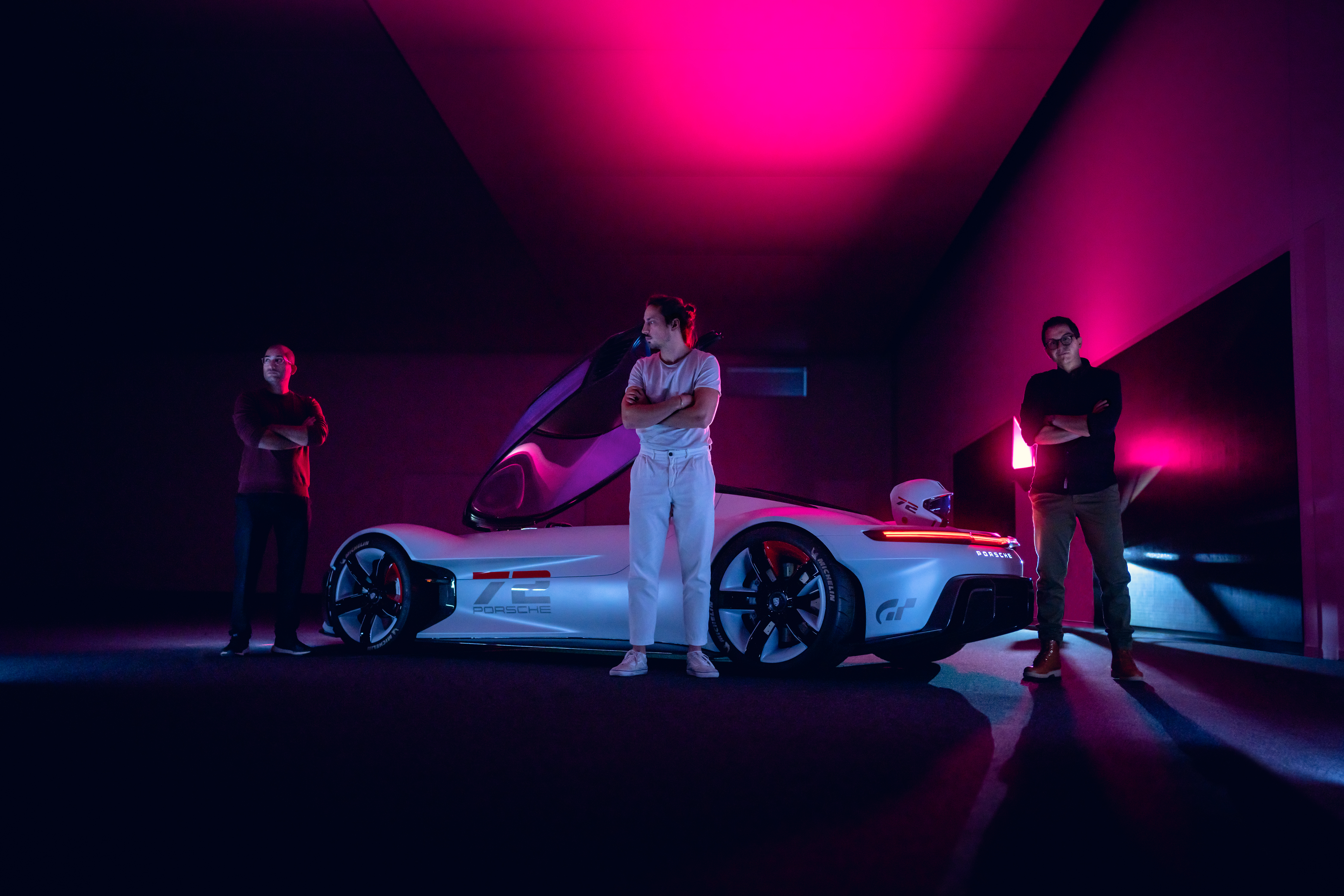 Three men in front of Porsche Vision GT concept car