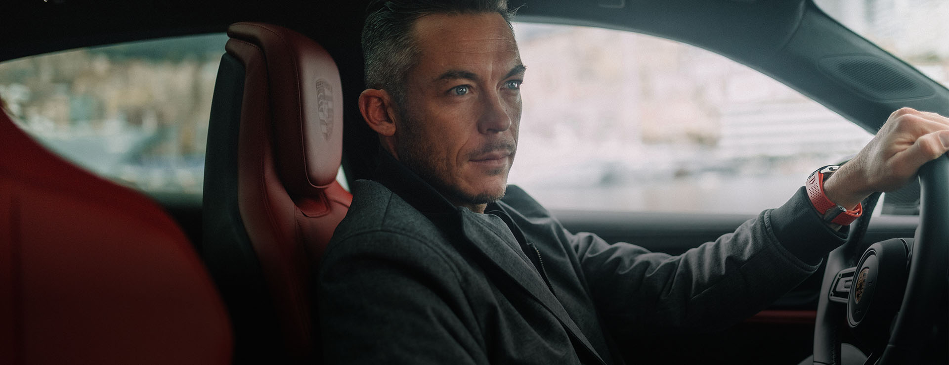 Racing driver André Lotterer behind the wheel of a Porsche Taycan Cross Turismo