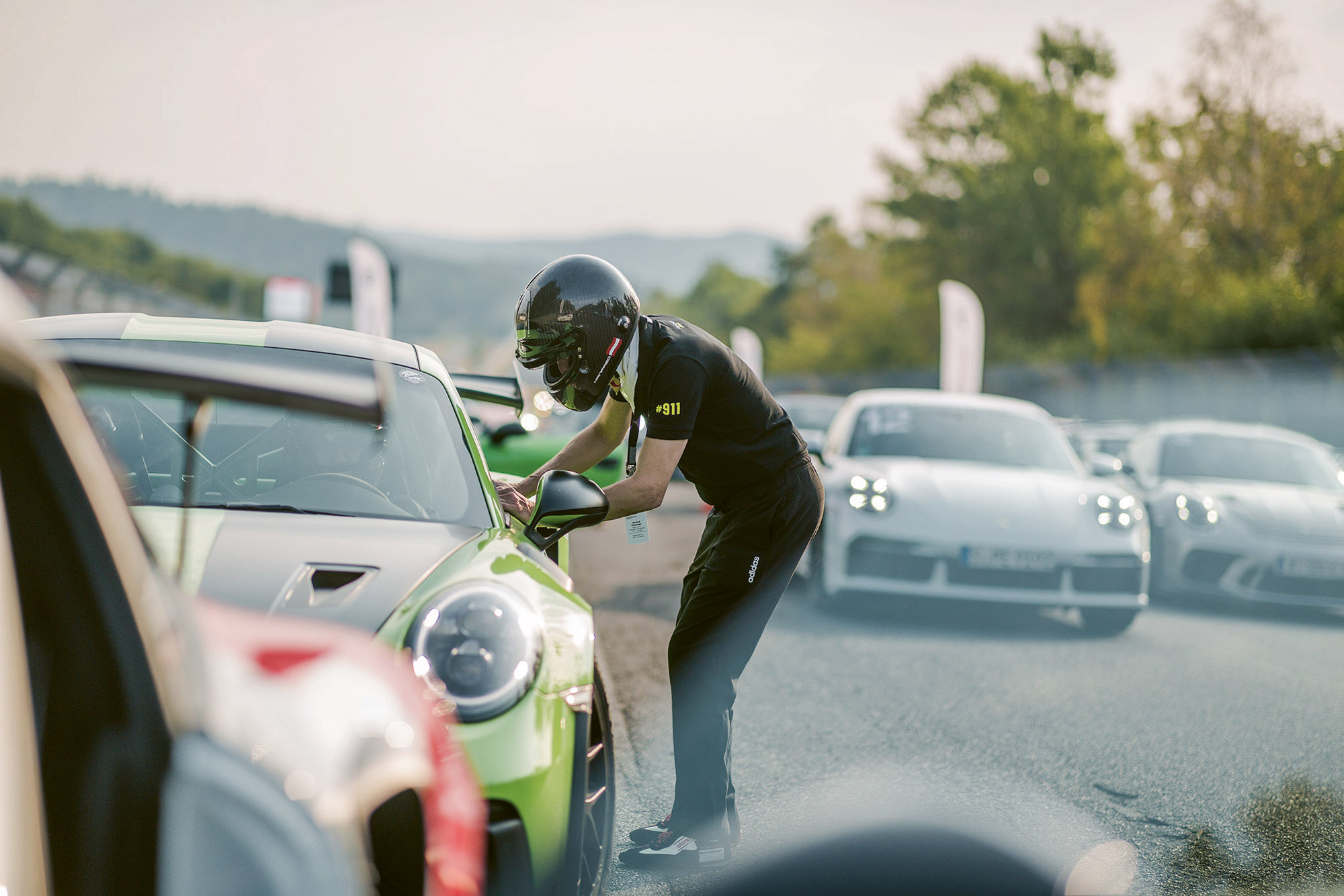 An instructor in a helmet talks with a driver
