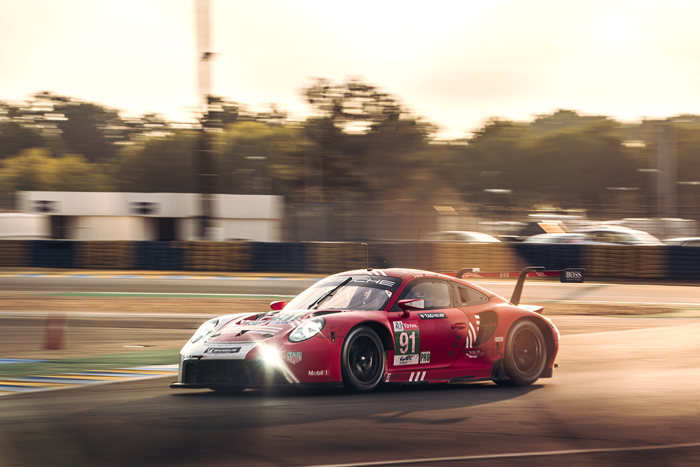 Red Porsche 911 RSR racecar on track at Le Mans in 2020