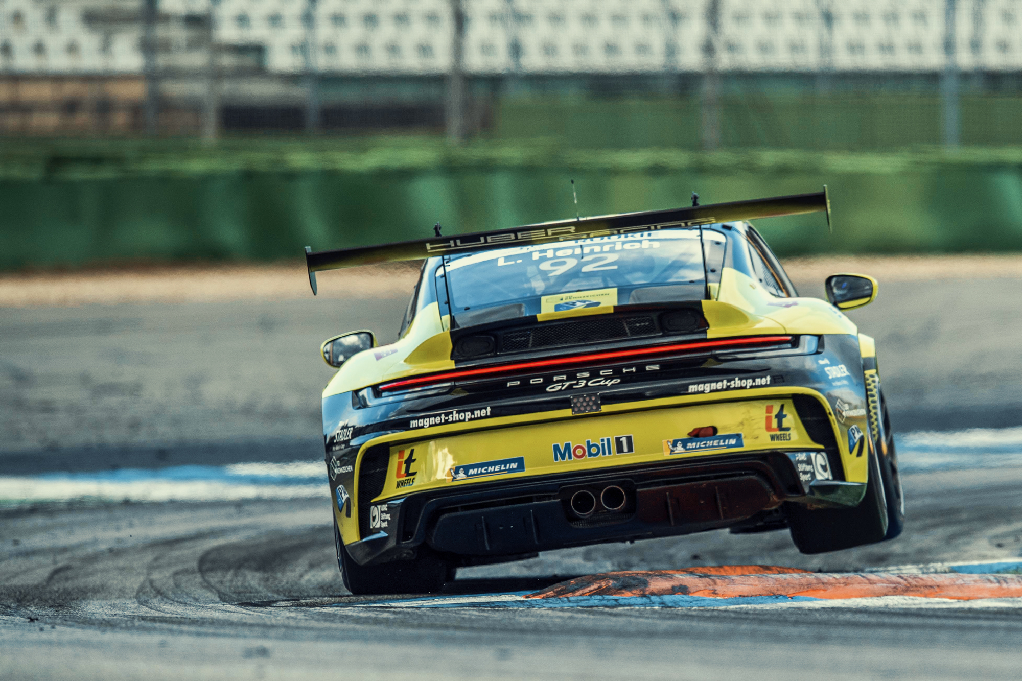 Rear of a Porsche GT3 Cup car cornering on track