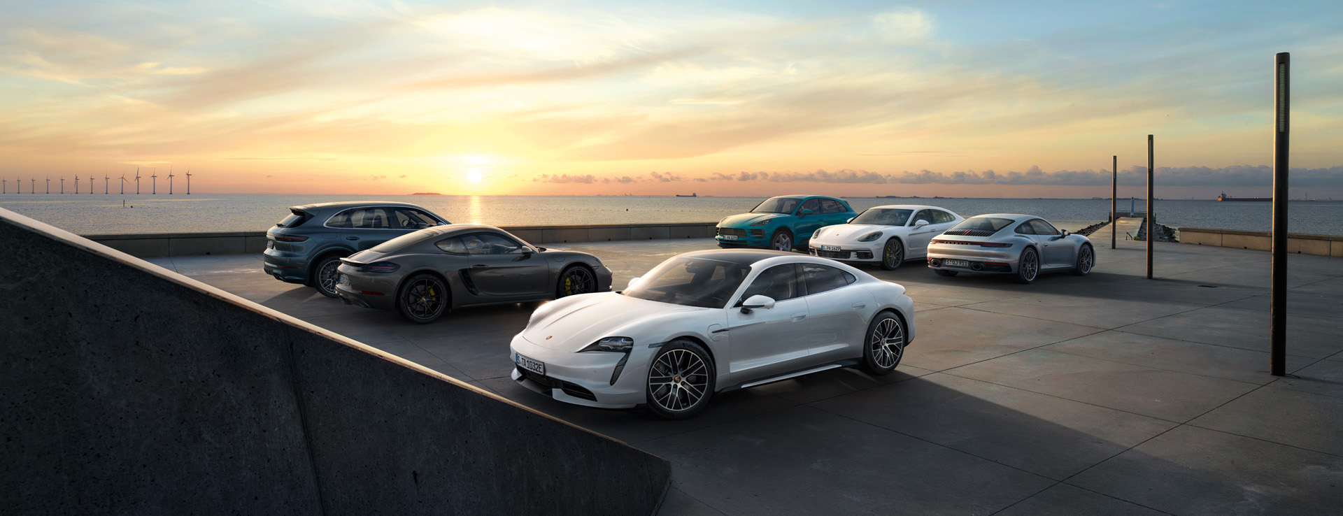 Sunset view of Porsche models next to the sea