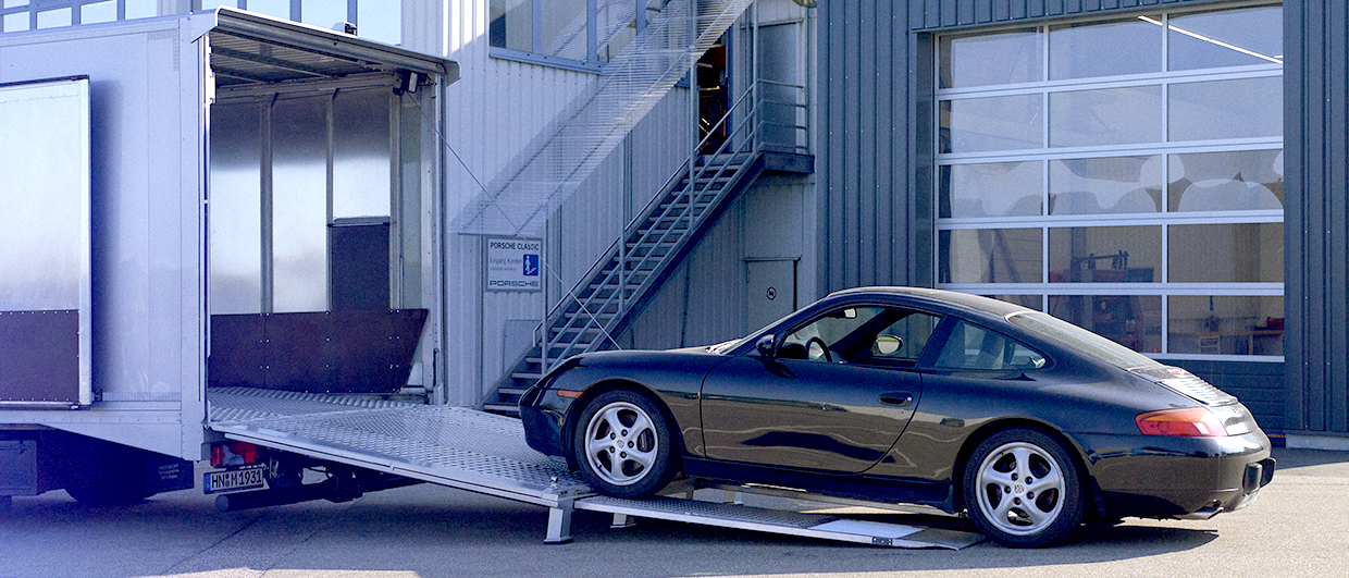 Porsche 996 being loaded onto a trailer at Porsche Classic
