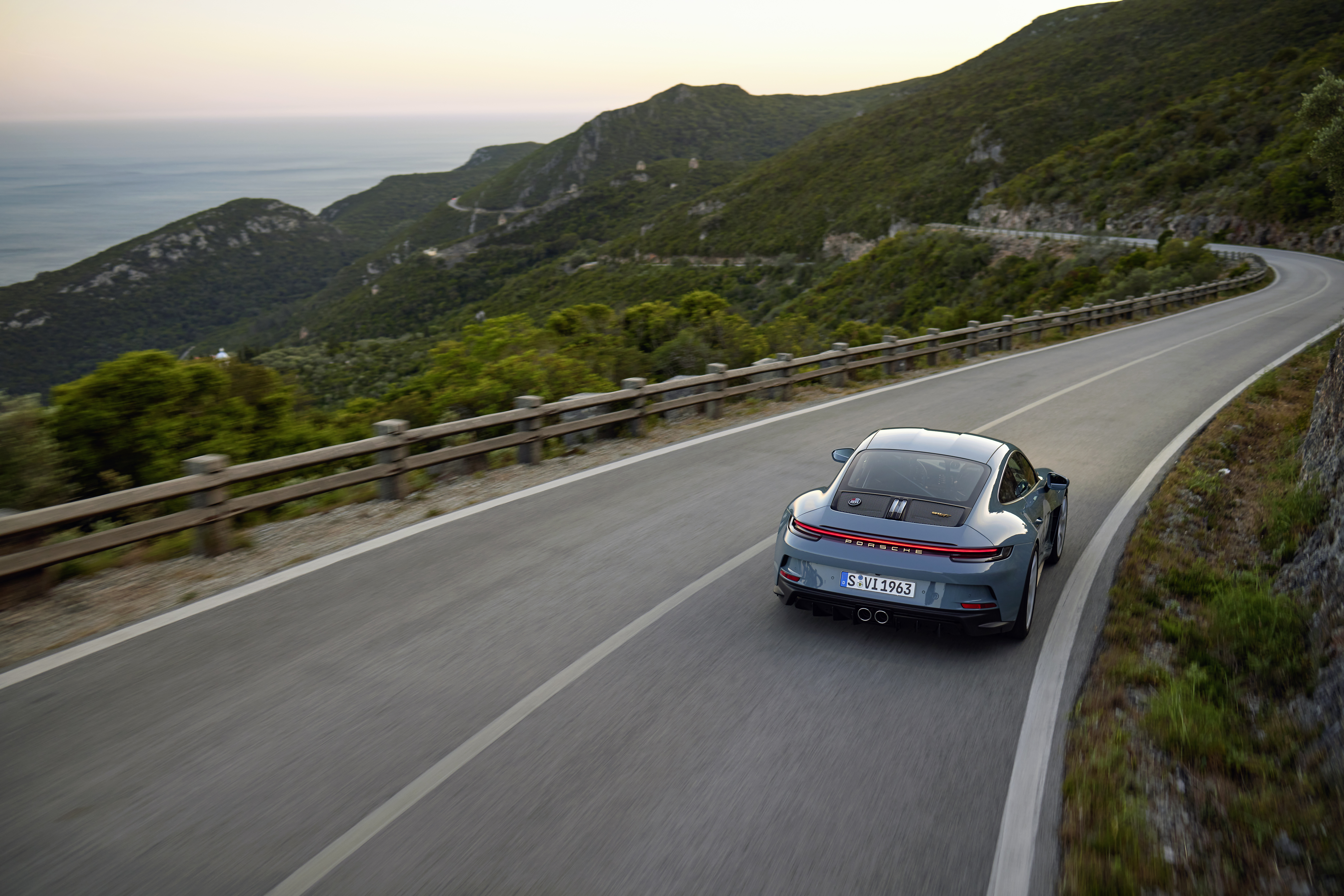 Rear view of Porsche 911 S/T driving on coastal road