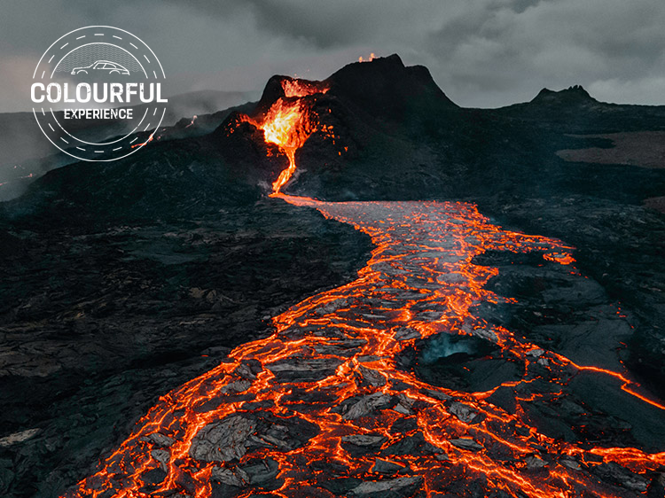 River of orange lava flows down from Mount Etna, Sicily