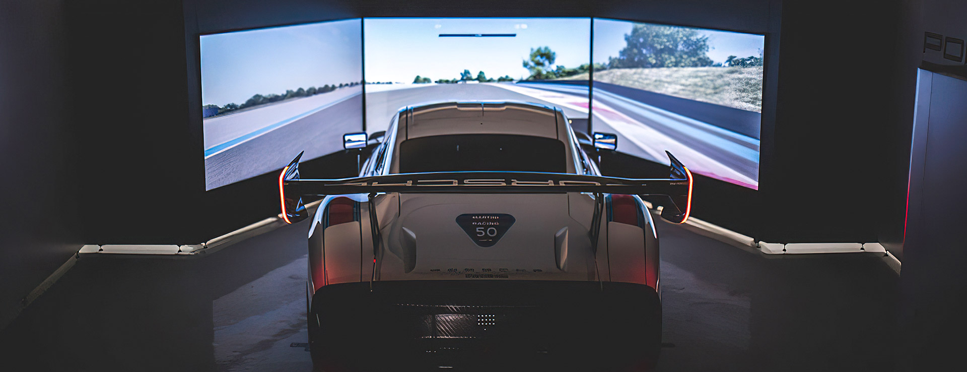 Image of Porsche Simulator car overlooking three large screens