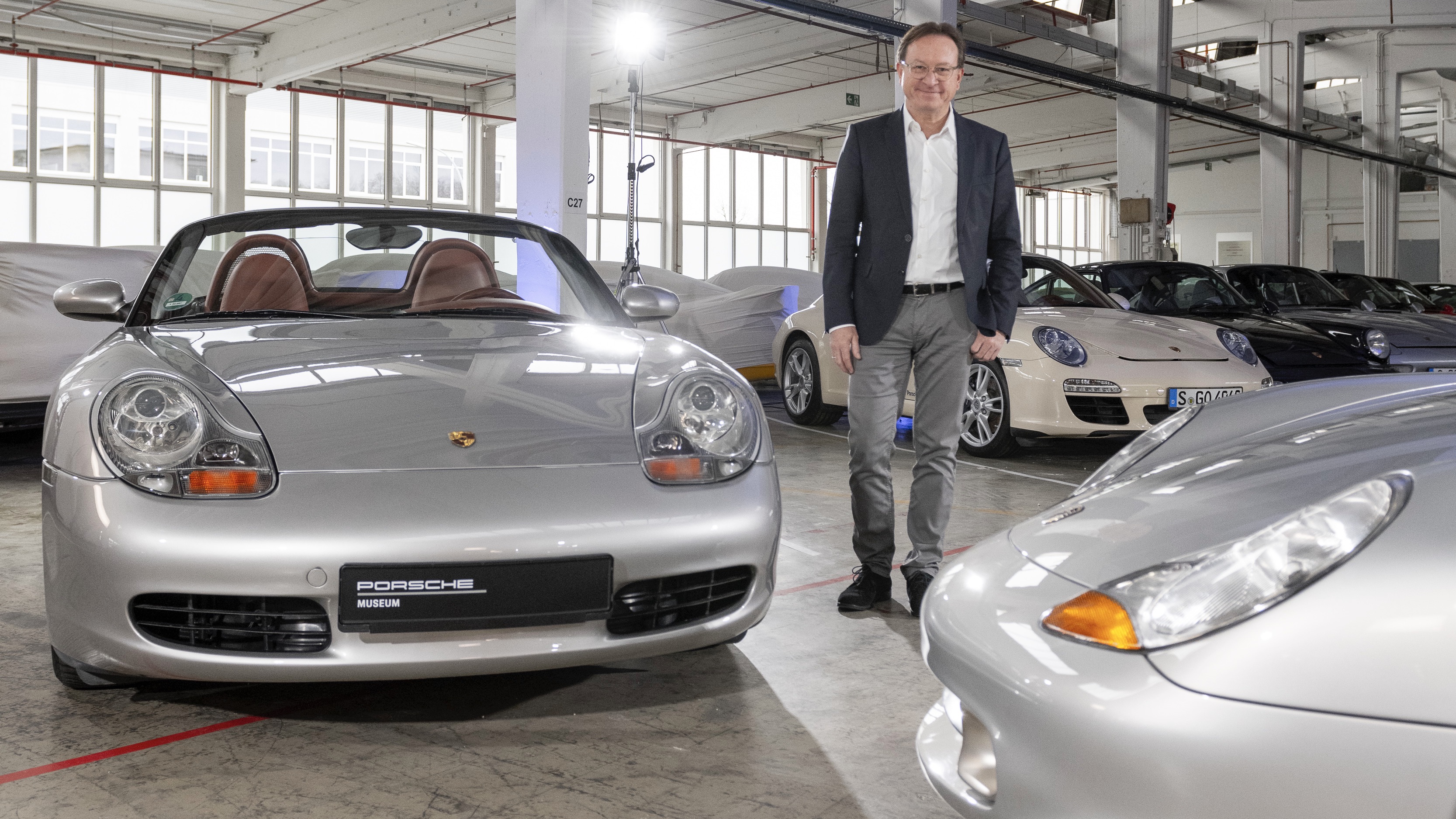 Grant Larson between two Boxsters at the Porsche Museum