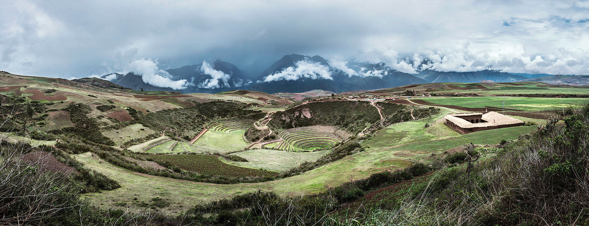 Inca ruins in Moray, Andean peaks in the background