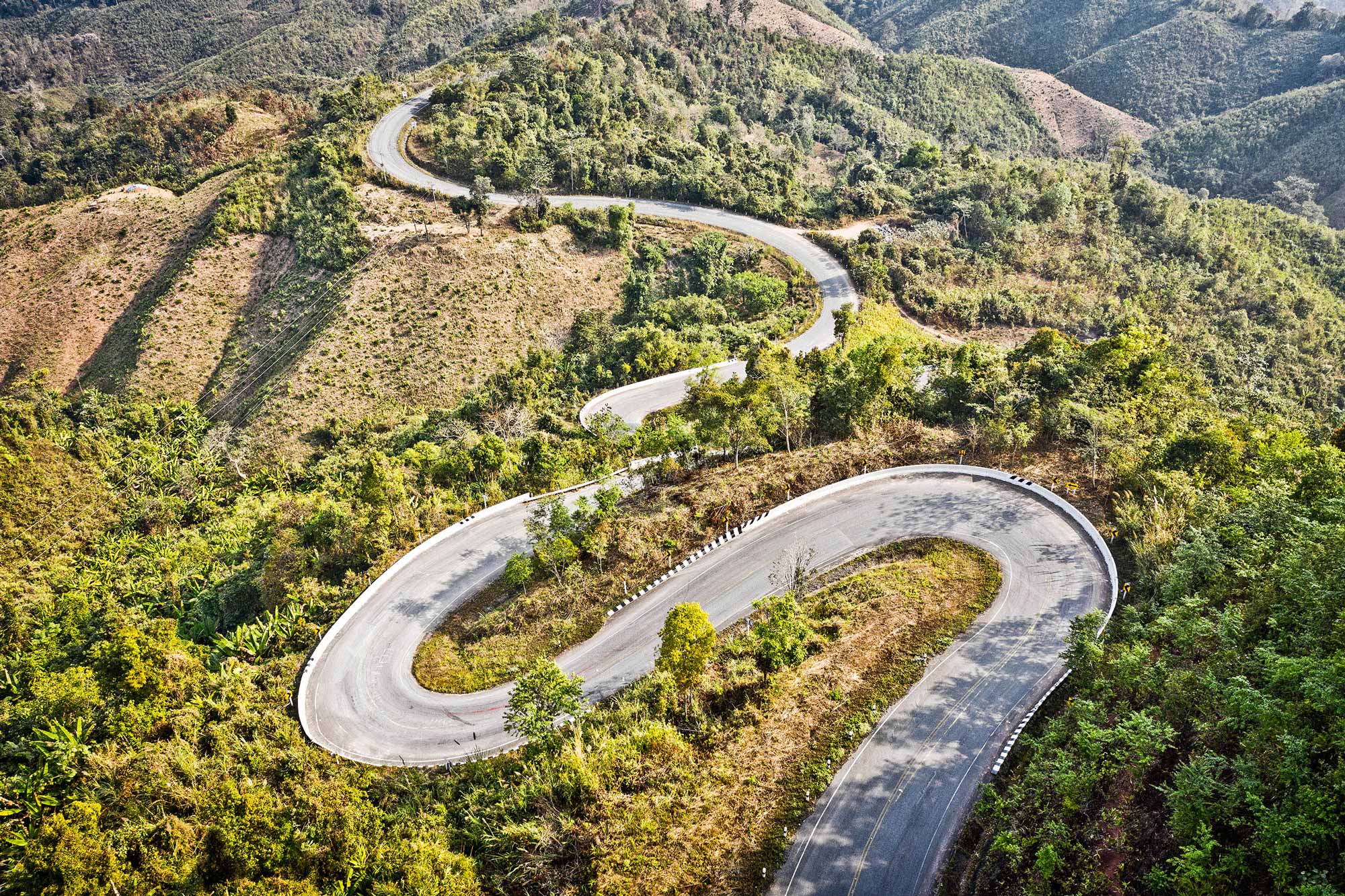 Serpentine switchback in the green mountains of Nan, Thailand