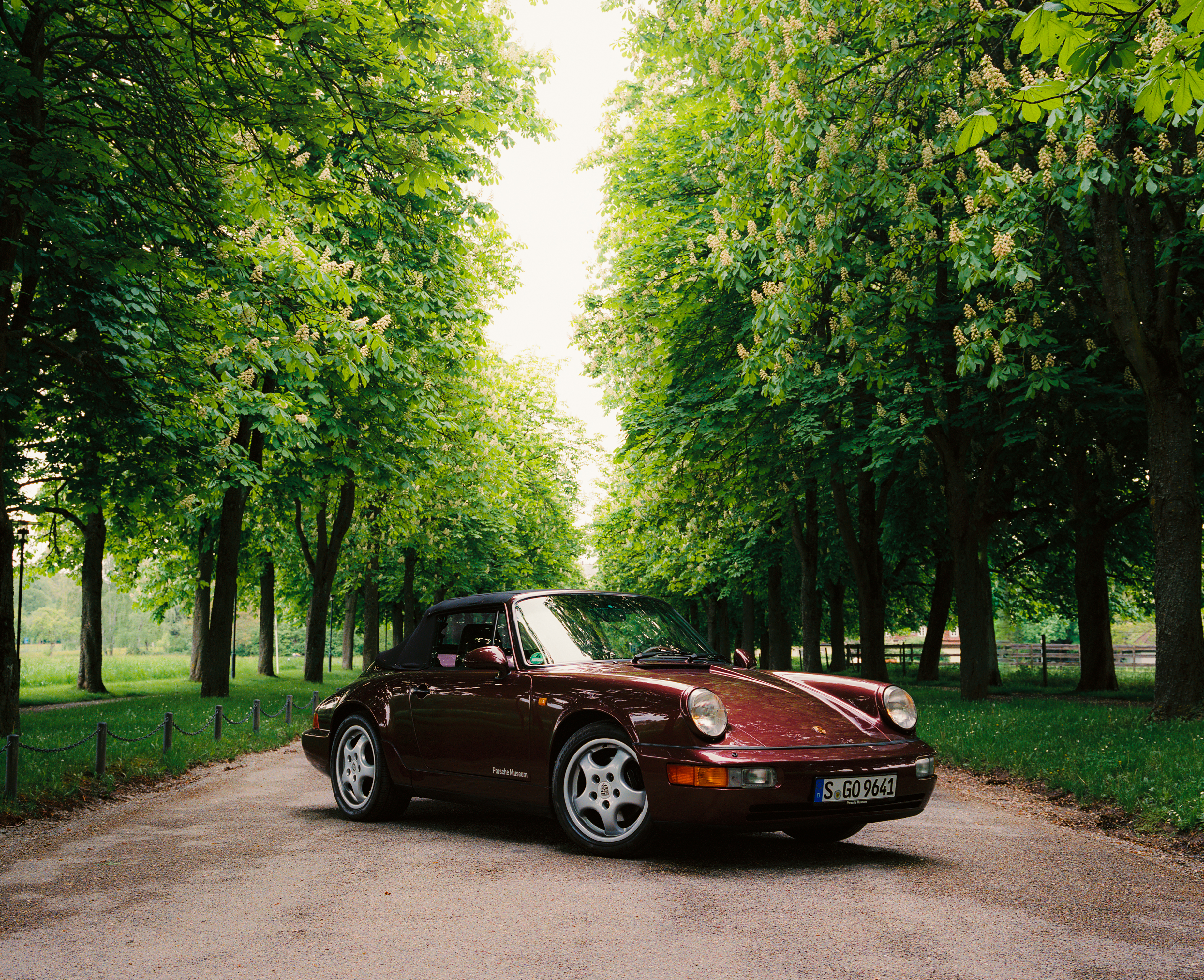 Porsche 911 Carrera 2 Cabriolet (type 964) on tree-lined road