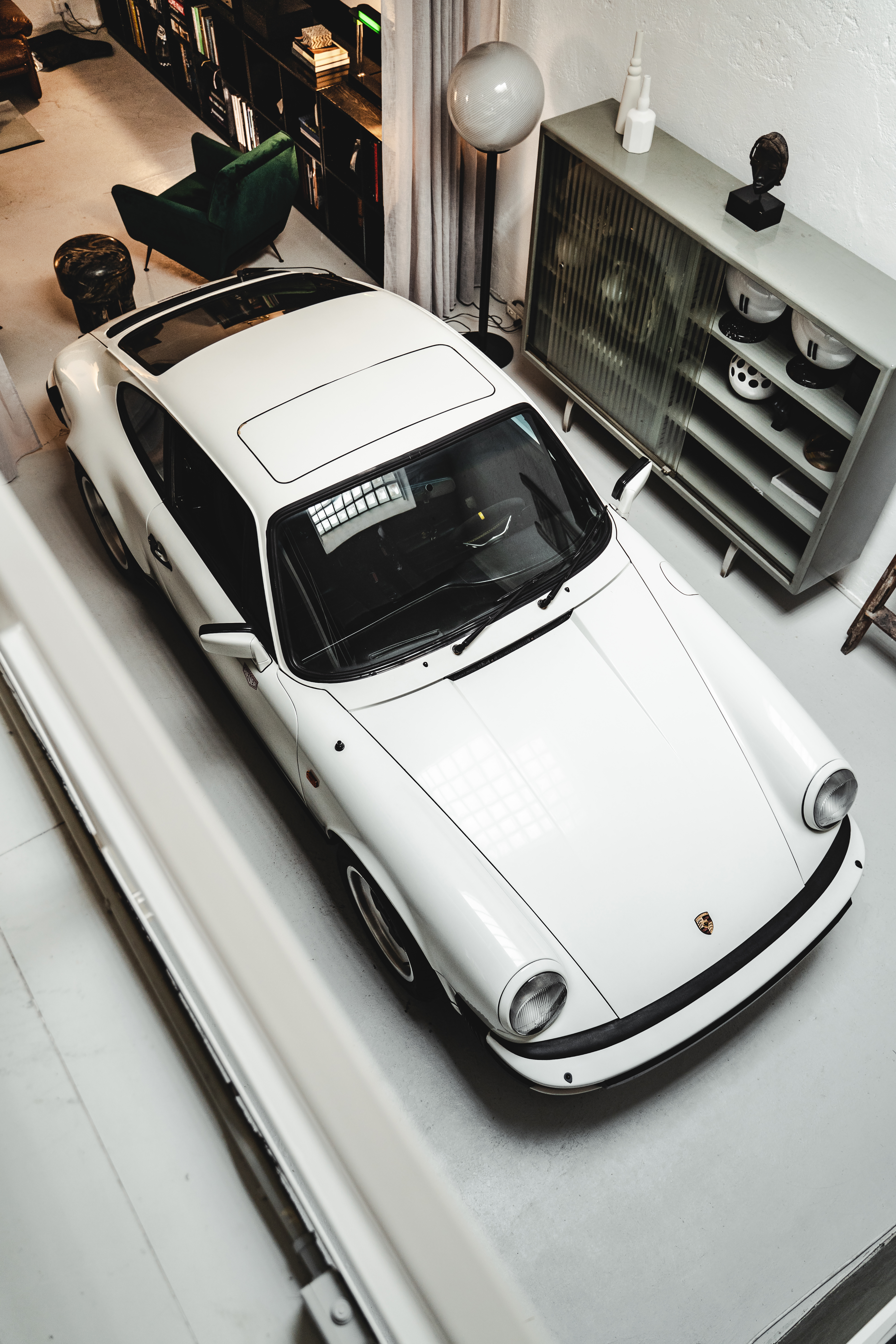 White Porsche 911 SC in a white-coloured loft space