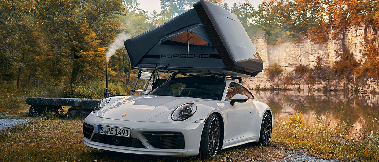 White Porsche 911 with Porsche rooftent by water