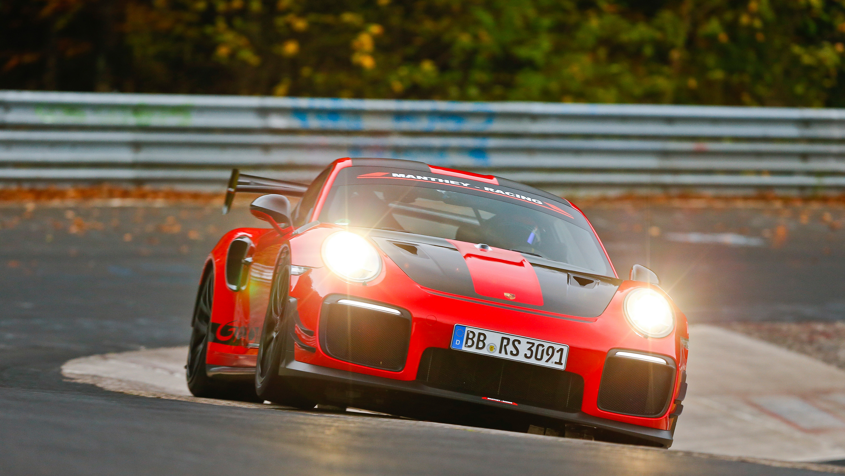 Red and black Porsche 911 GT2 RS breaking Nürburgring record