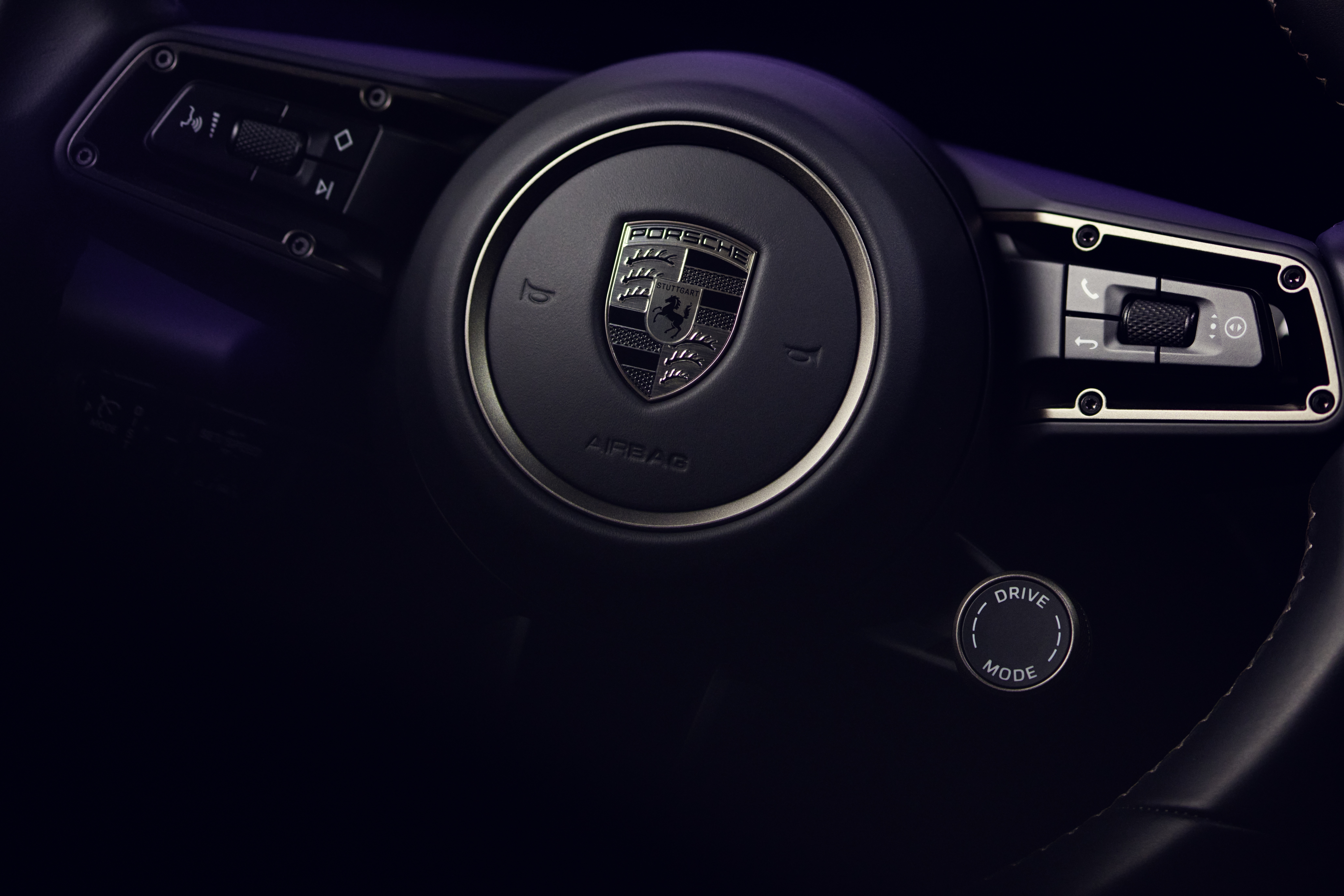 Close-up of Turbonite steering wheel of electric Porsche Macan Turbo