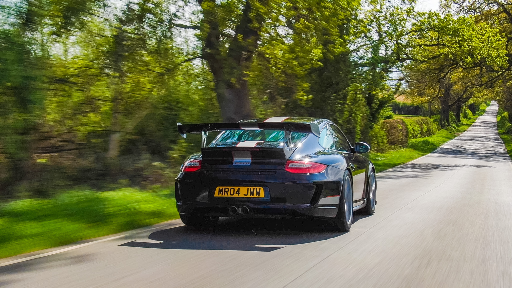 Porsche 911 GT3 RS 4.0 driving on a country road