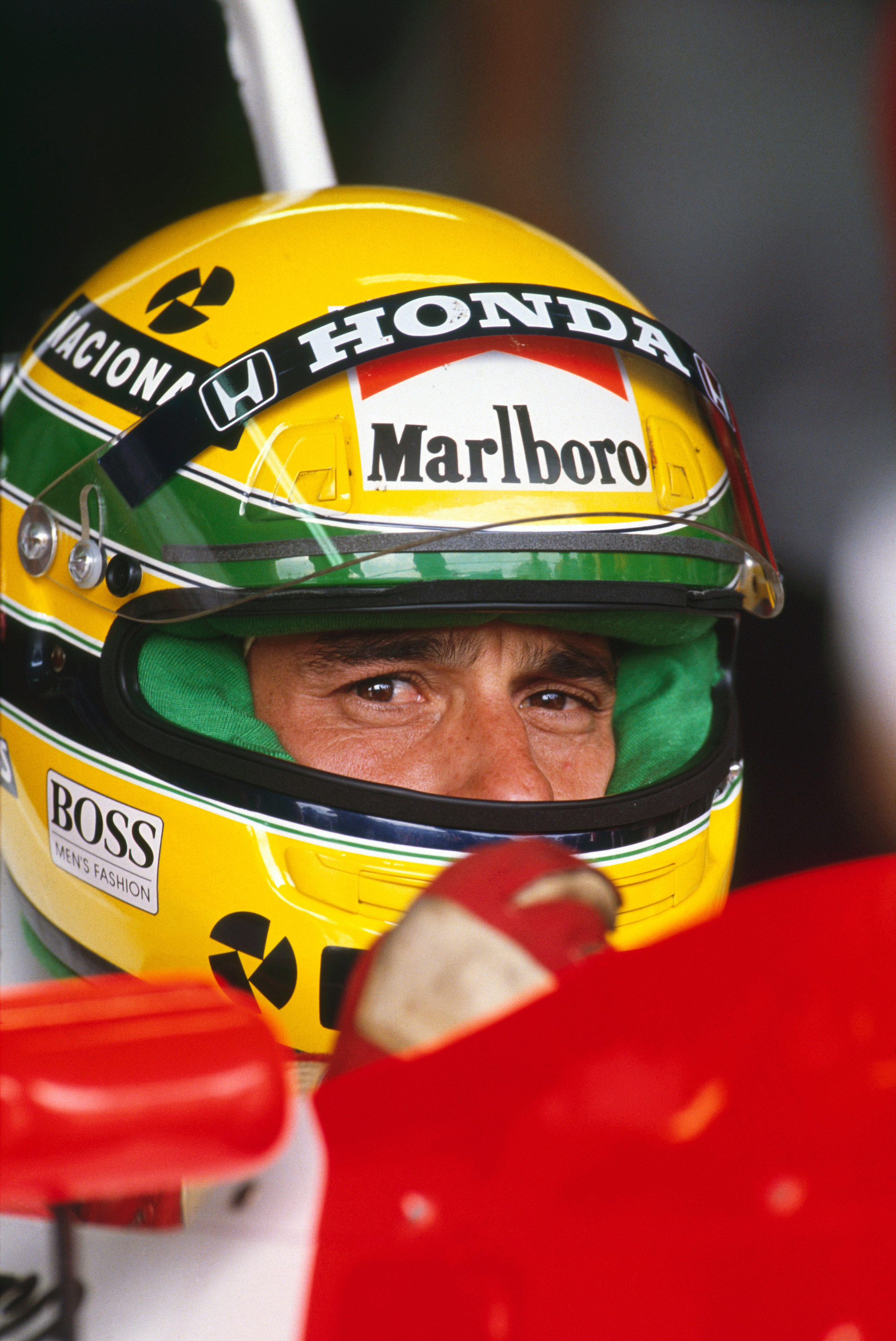 Ayrton Senna wearing yellow helmet with green stripes