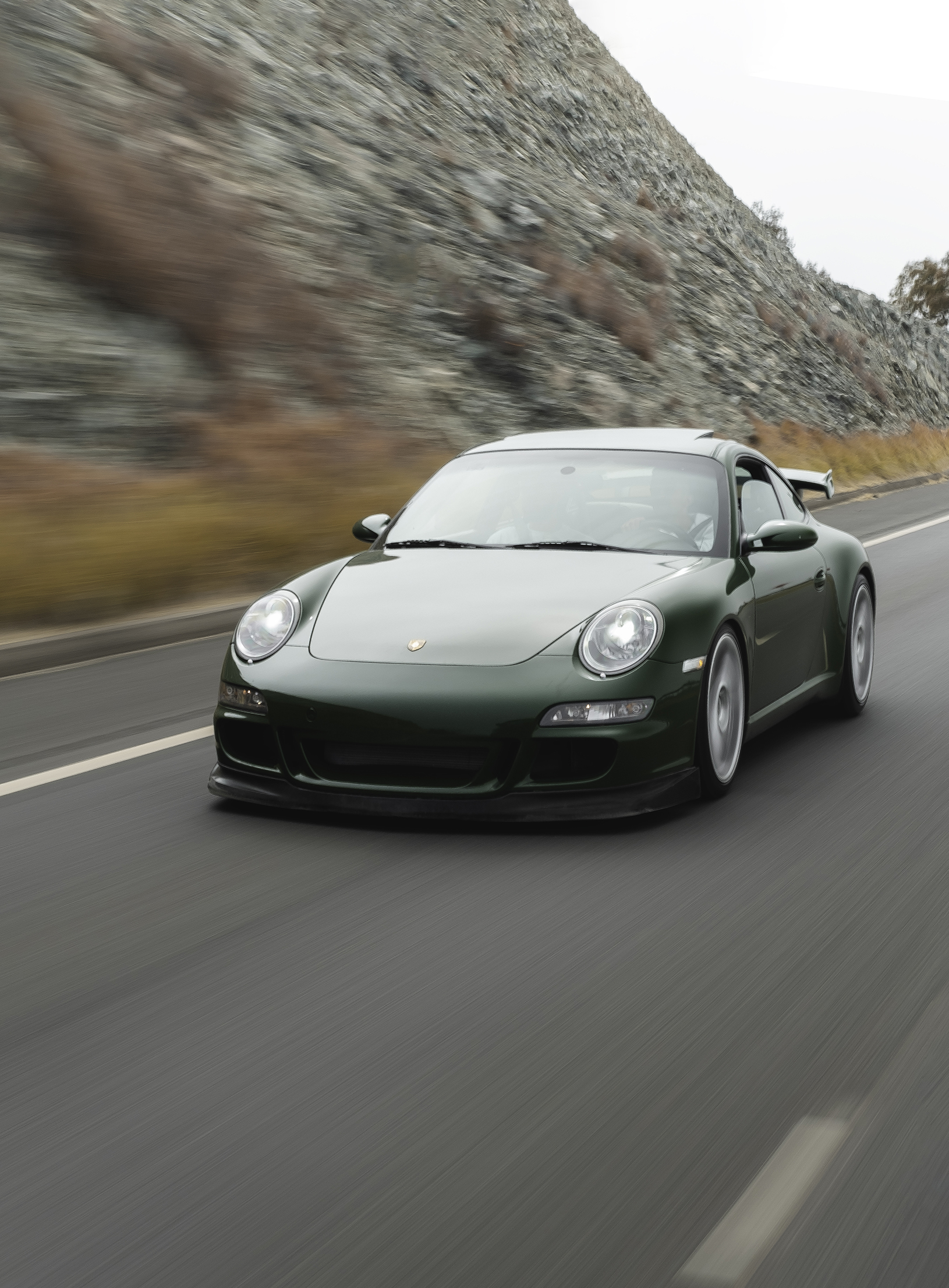 Dark green Porsche 911 (type 997.1) on road