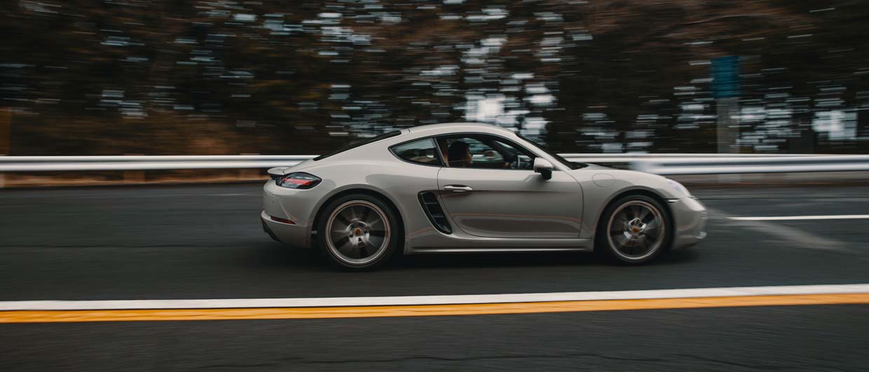 Porsche 718 Cayman in crayon colour on the road