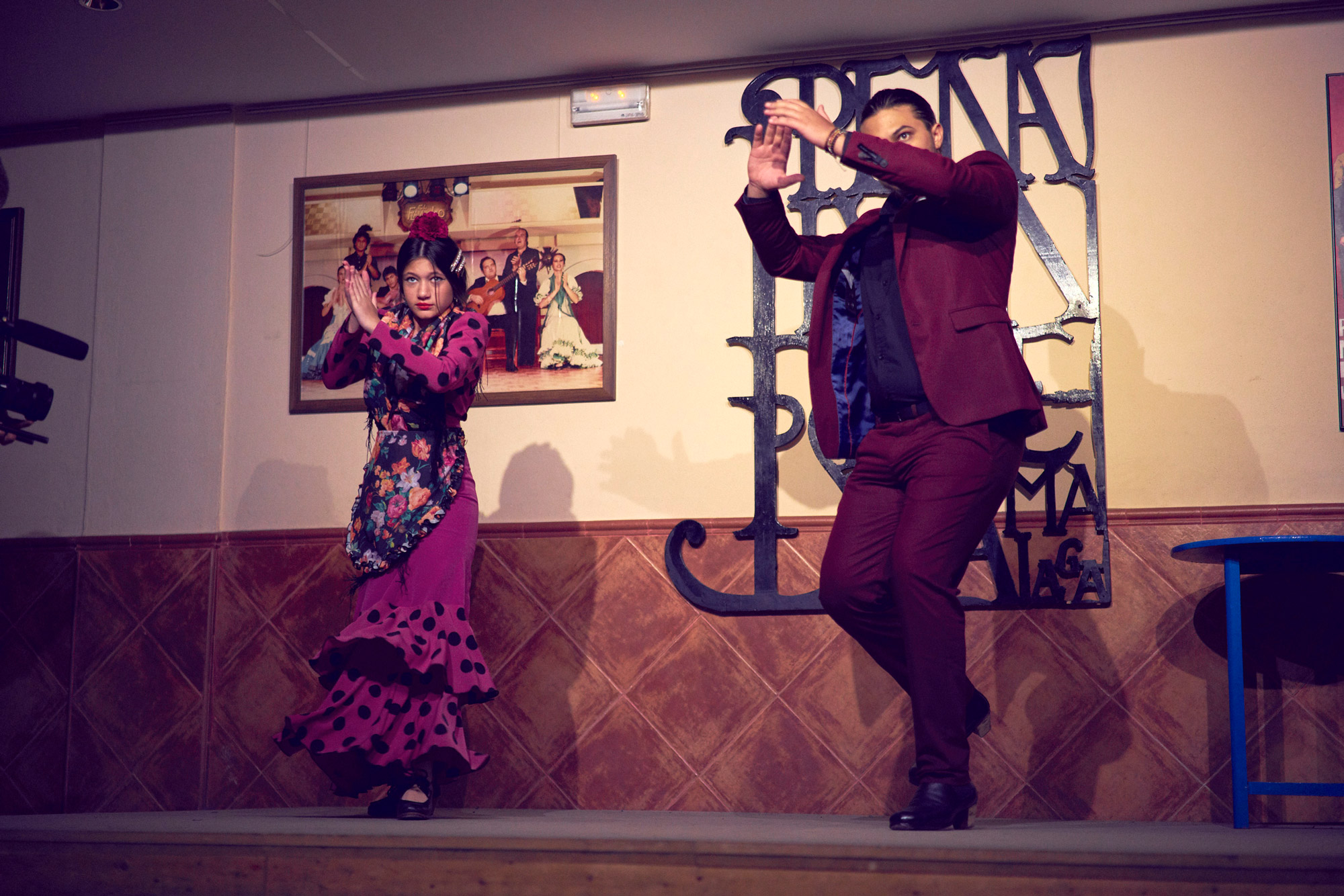 Flamenco dancers in traditional clothing dancing on a stage