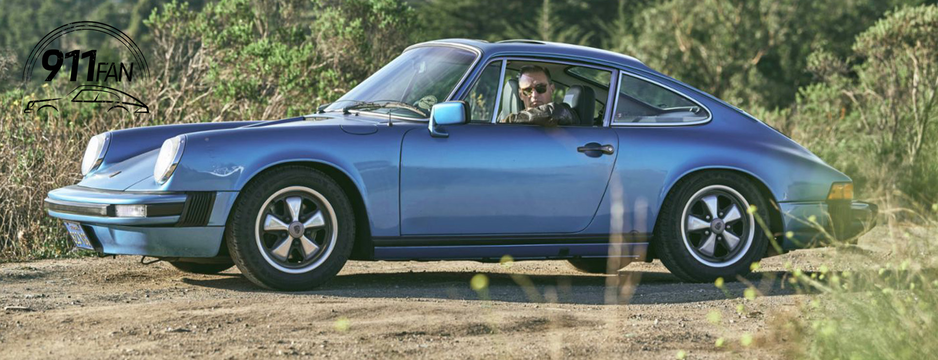 Minerva Blue classic Porsche 911 with woodland behind
