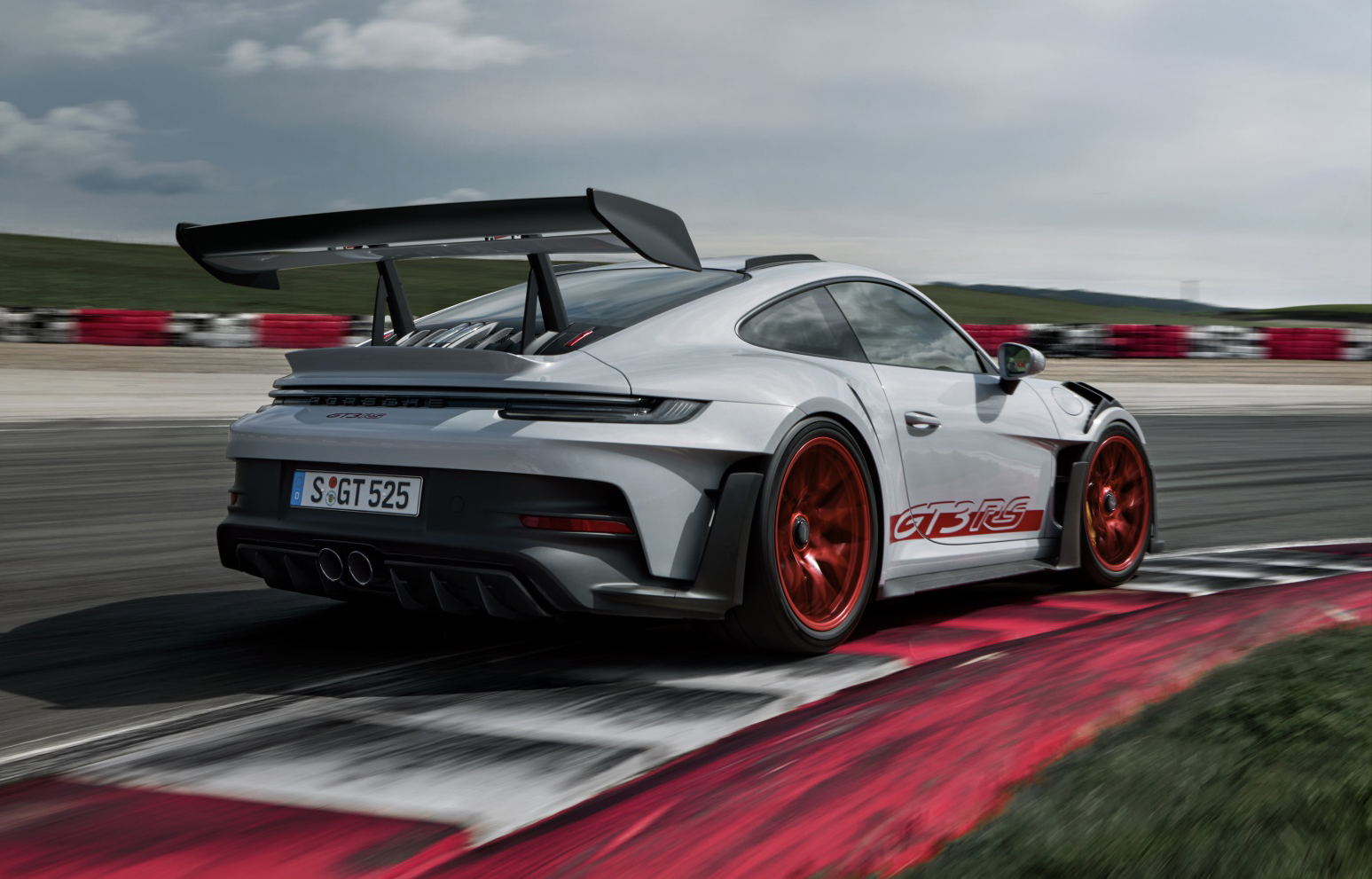 Side view of Porsche 911 GT3 RS racing on track