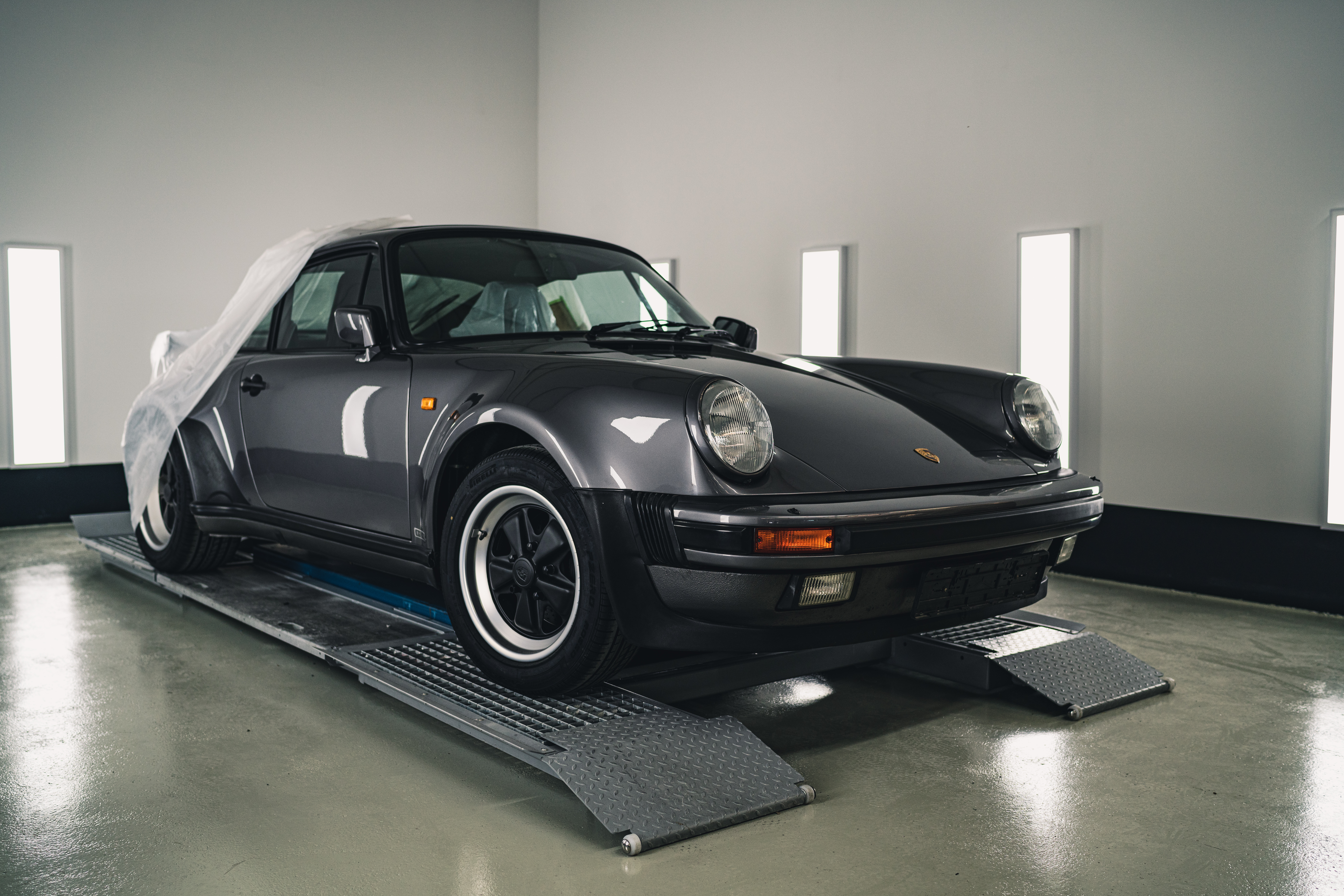 Porsche 911 revealed from beneath protective covers at Porsche Classic