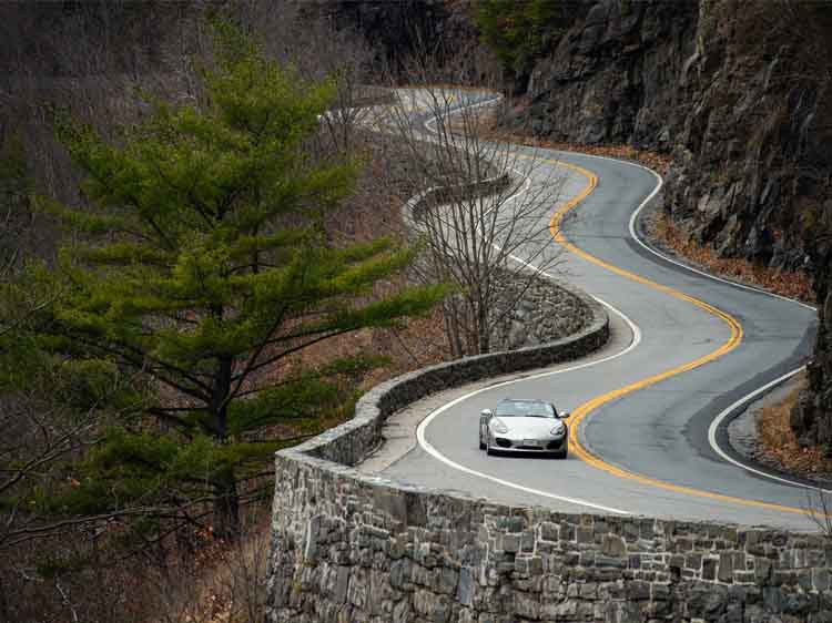 Porsche Boxster Spyder driving on a mountain road